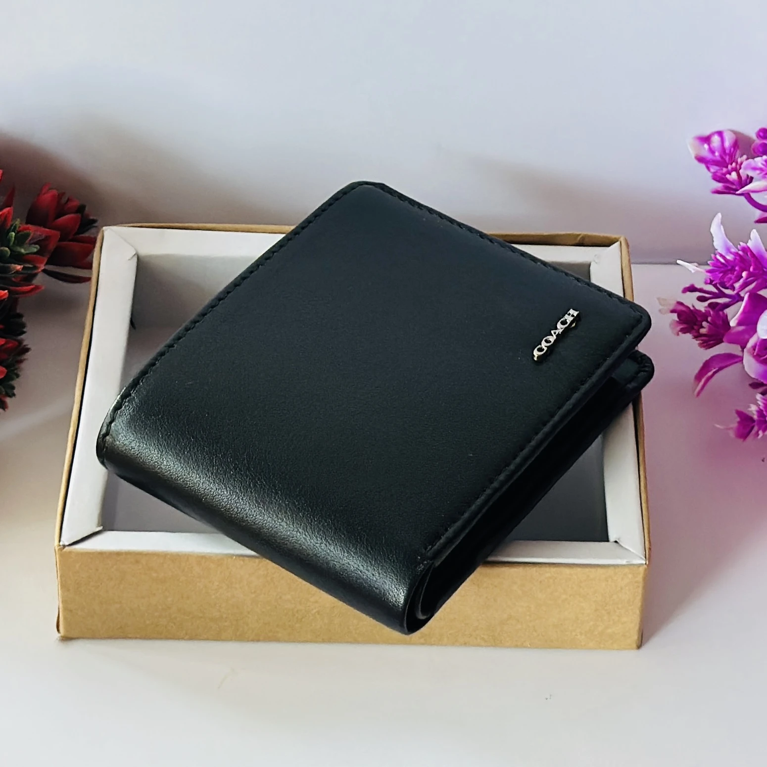 Black genuine leather bifold wallet from Coach.
