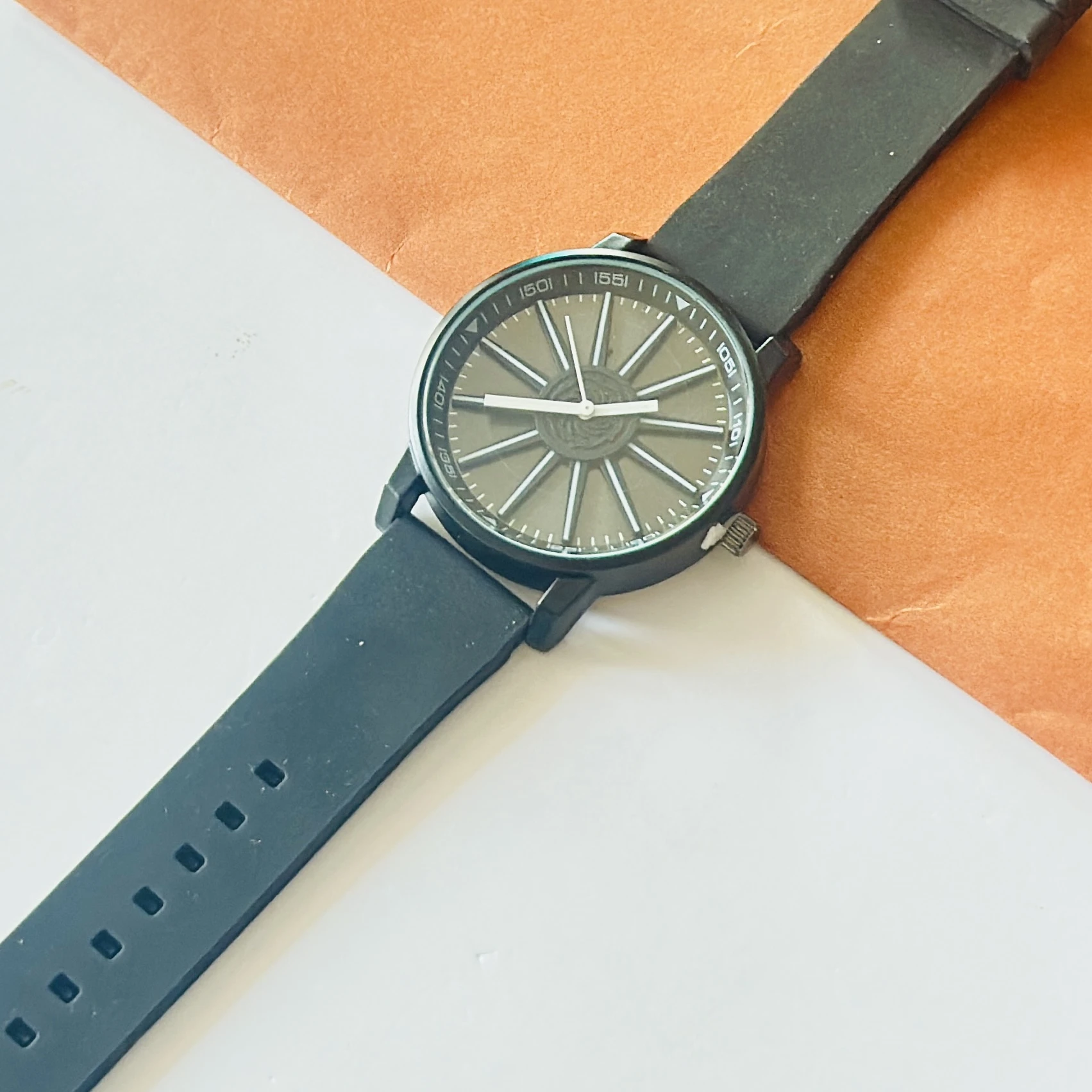 watch appears to be a V9 Collection black analog wristwatch with a silicone strap.