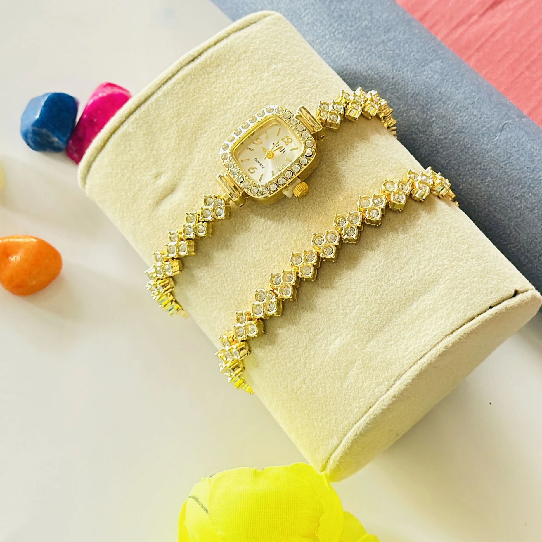 gold-tone Jiali quartz watch with a square dial and rhinestones.