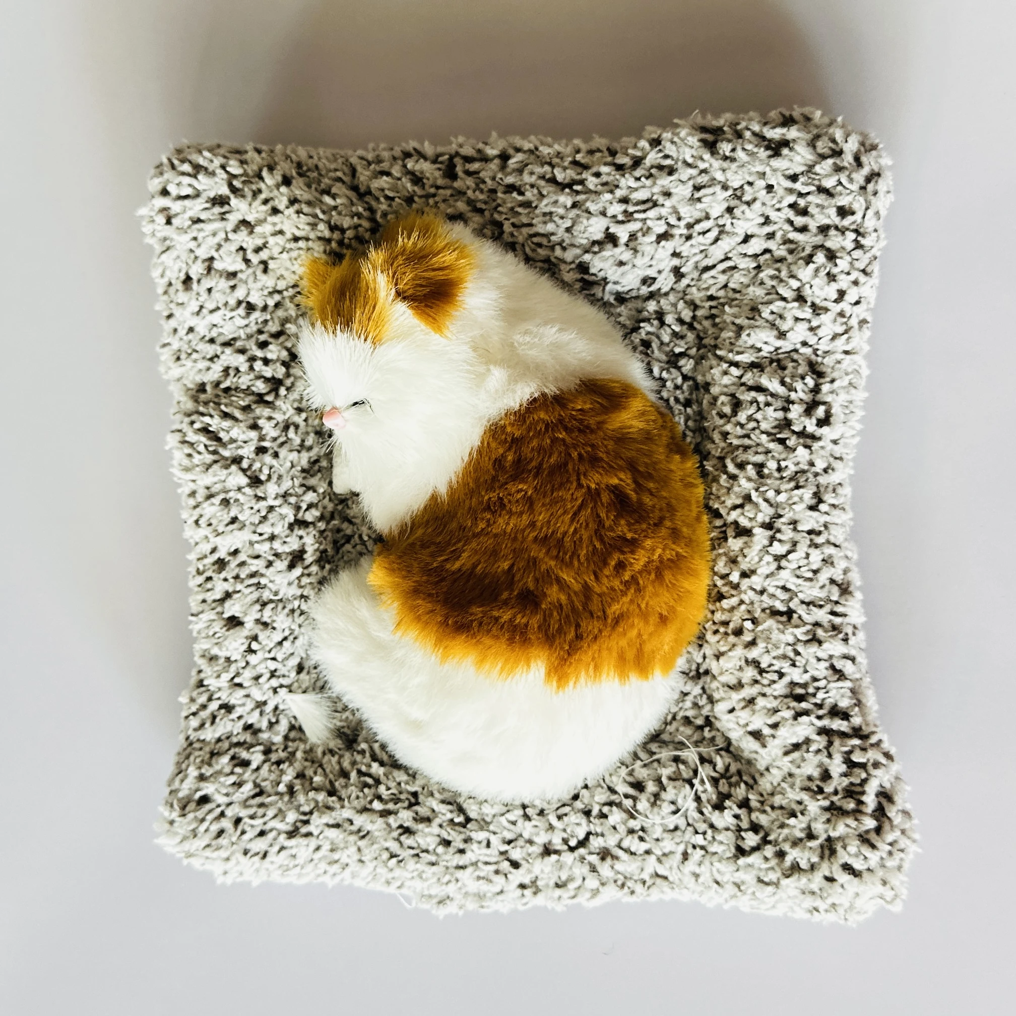 plush toy depicting a sleeping cat
