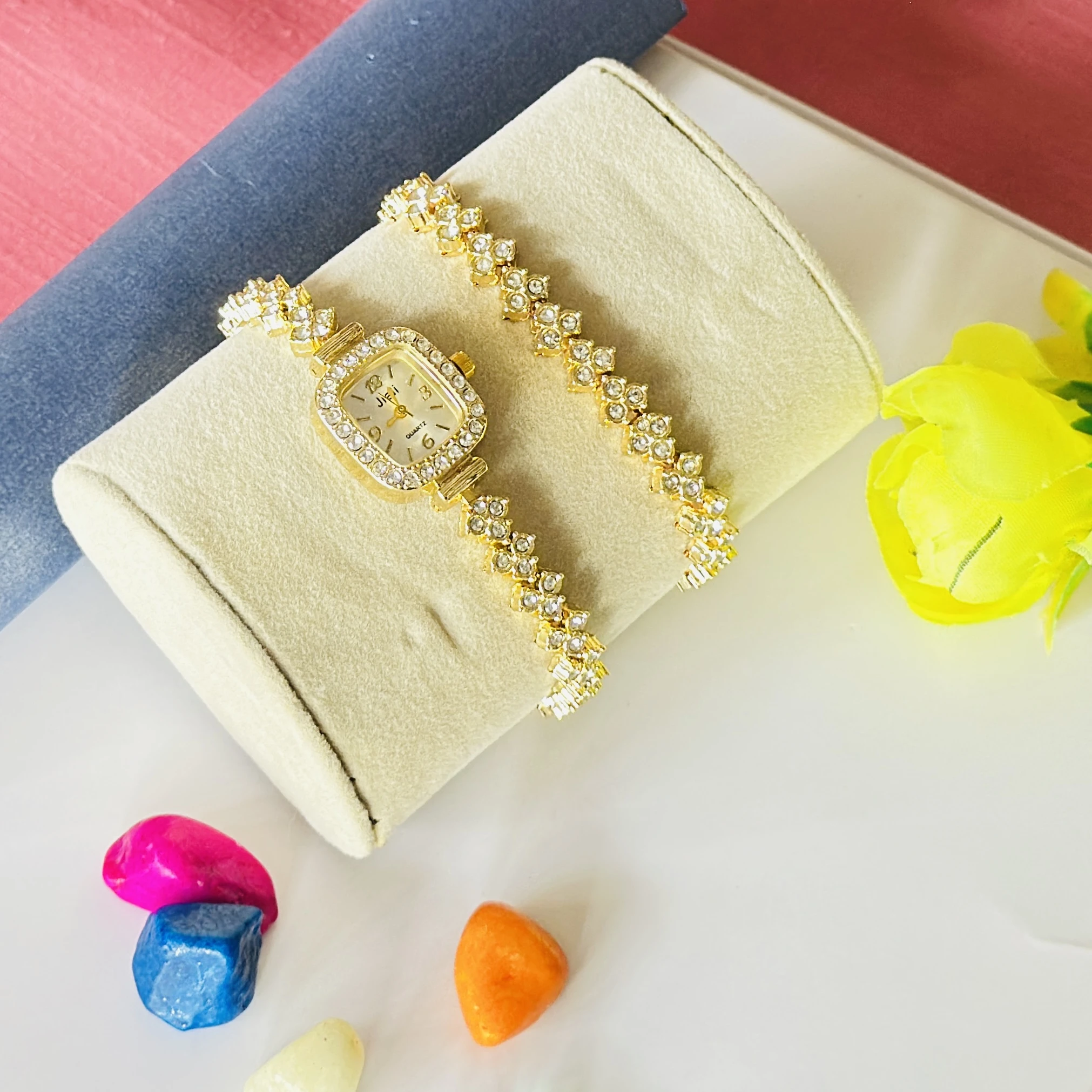 gold-tone Jiali quartz watch with a square dial and rhinestones.