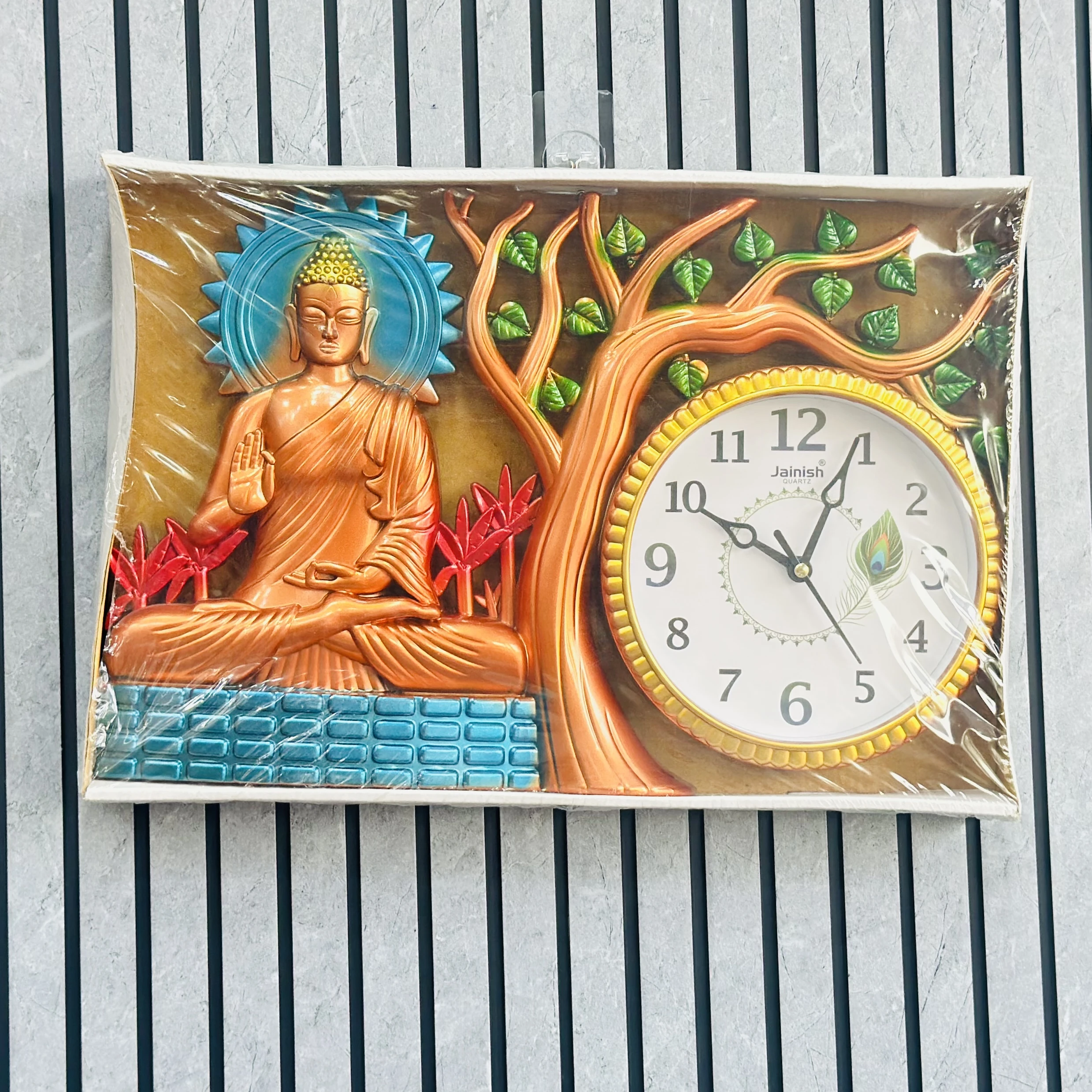 Wall clock featuring a depiction of Buddha under a tree.