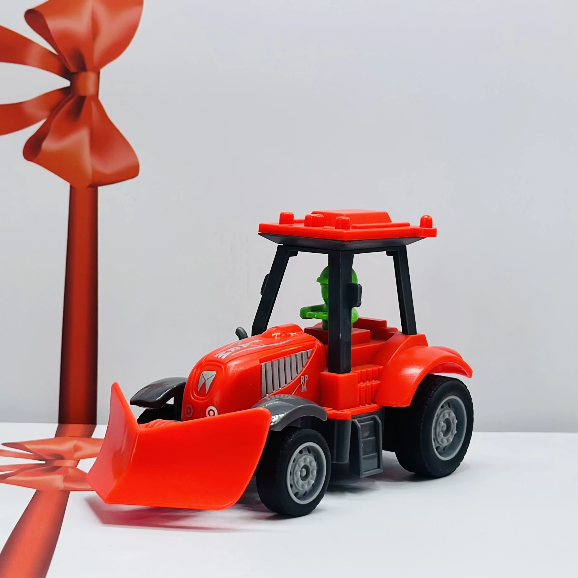 Red plastic toy tractor