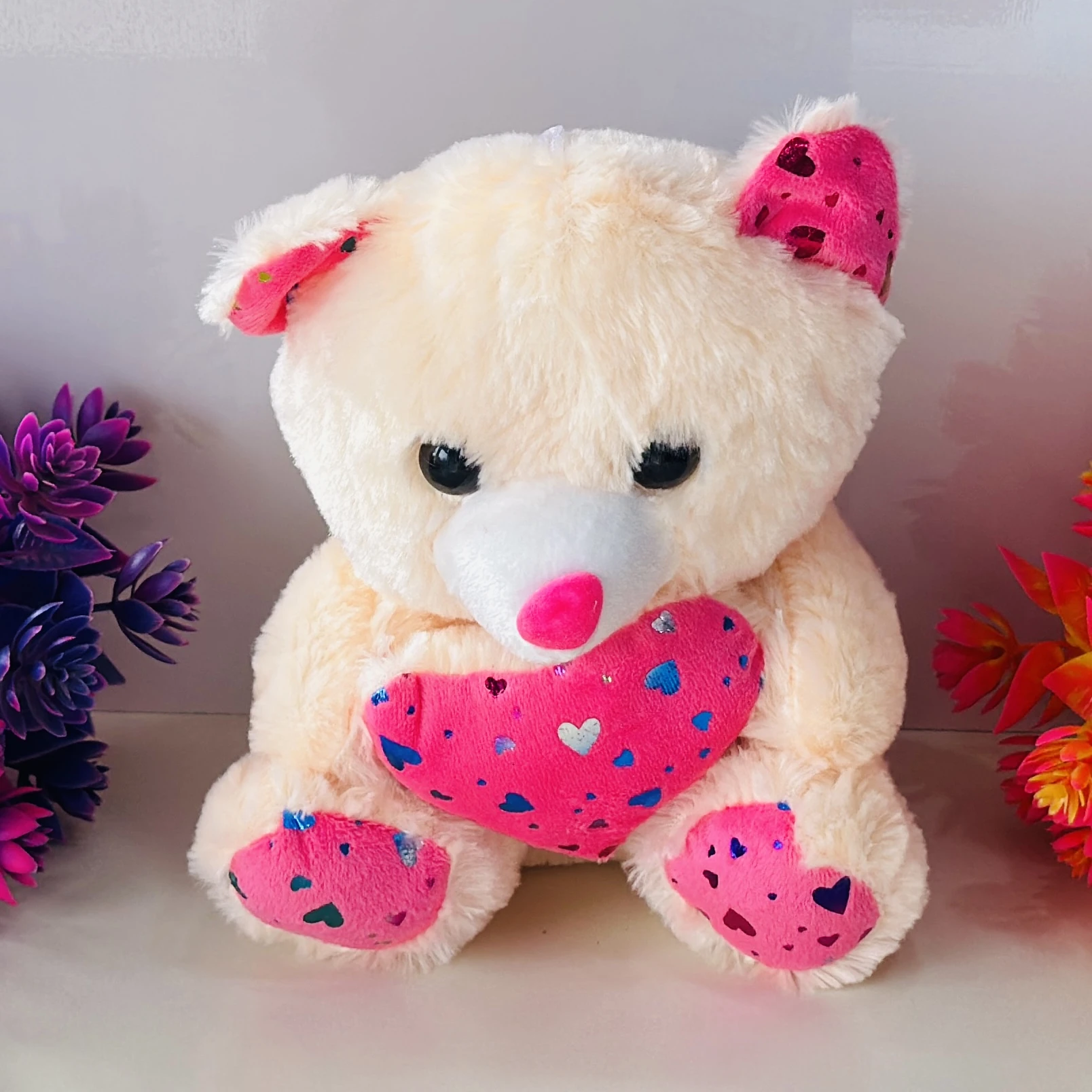 white teddy bear stuffed toy with a pink heart.
