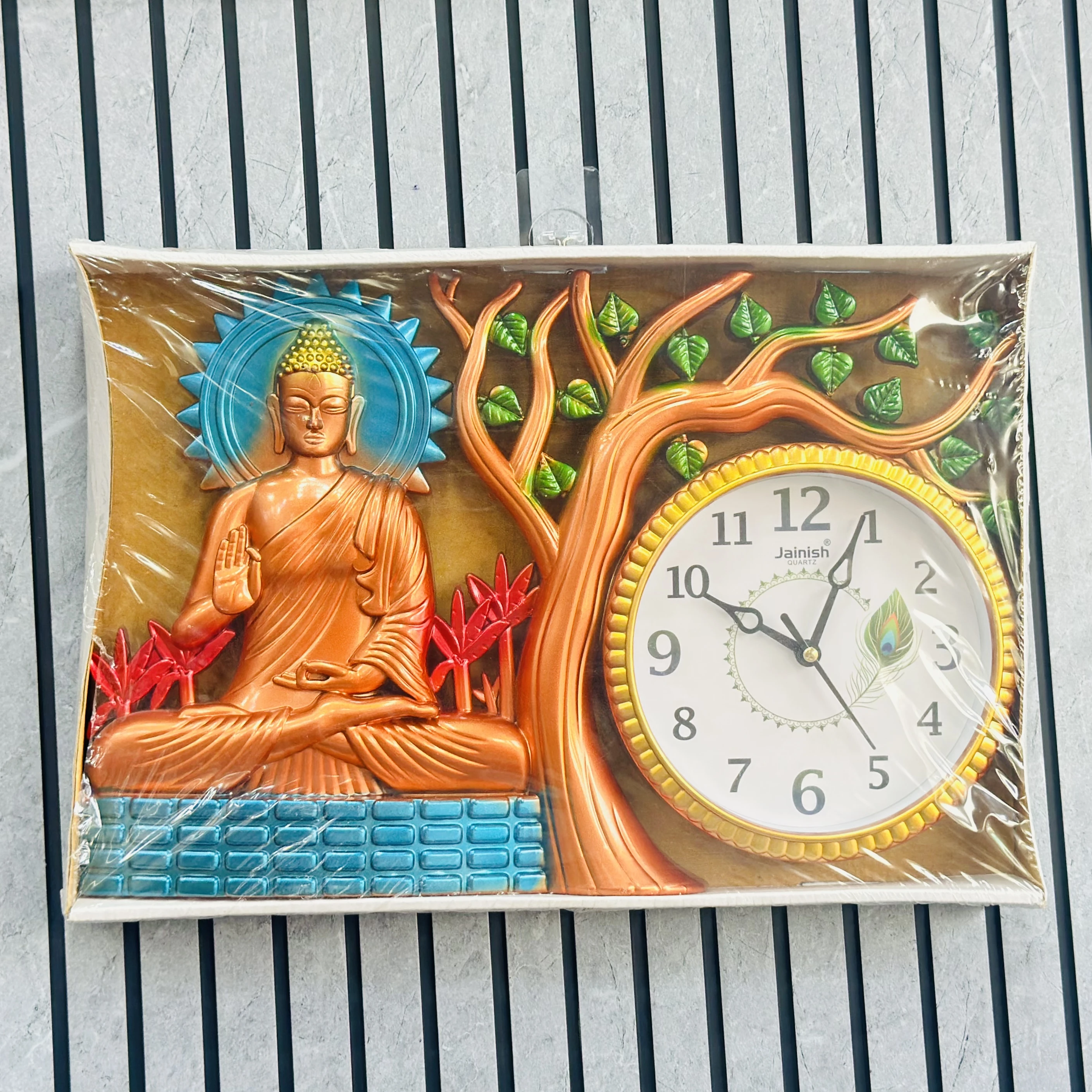 Wall clock featuring a depiction of Buddha under a tree.