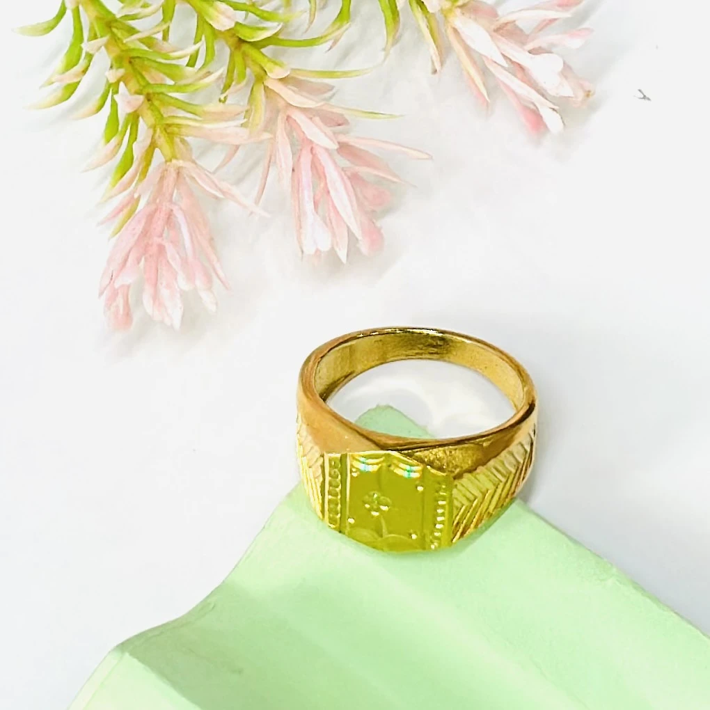 Gold toned signet ring with engraved detailing.
