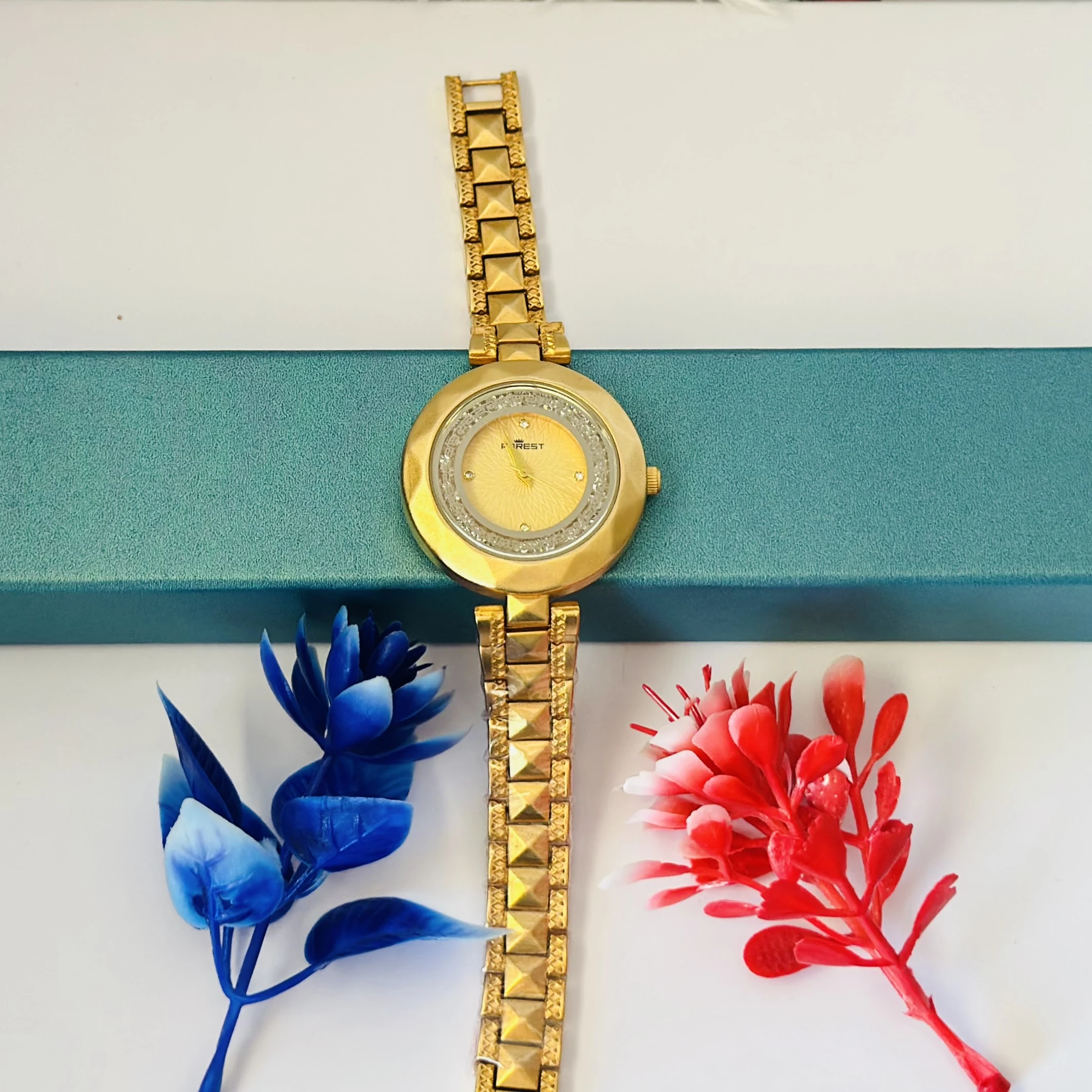 analog watch for women with a golden dial and band.