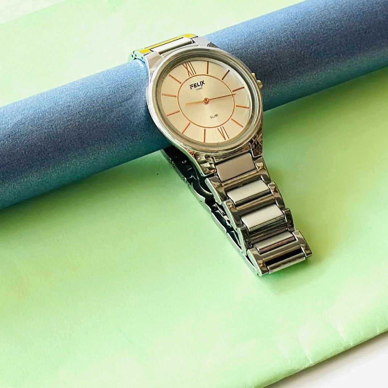 Felix Time slim stainless steel analog watch.