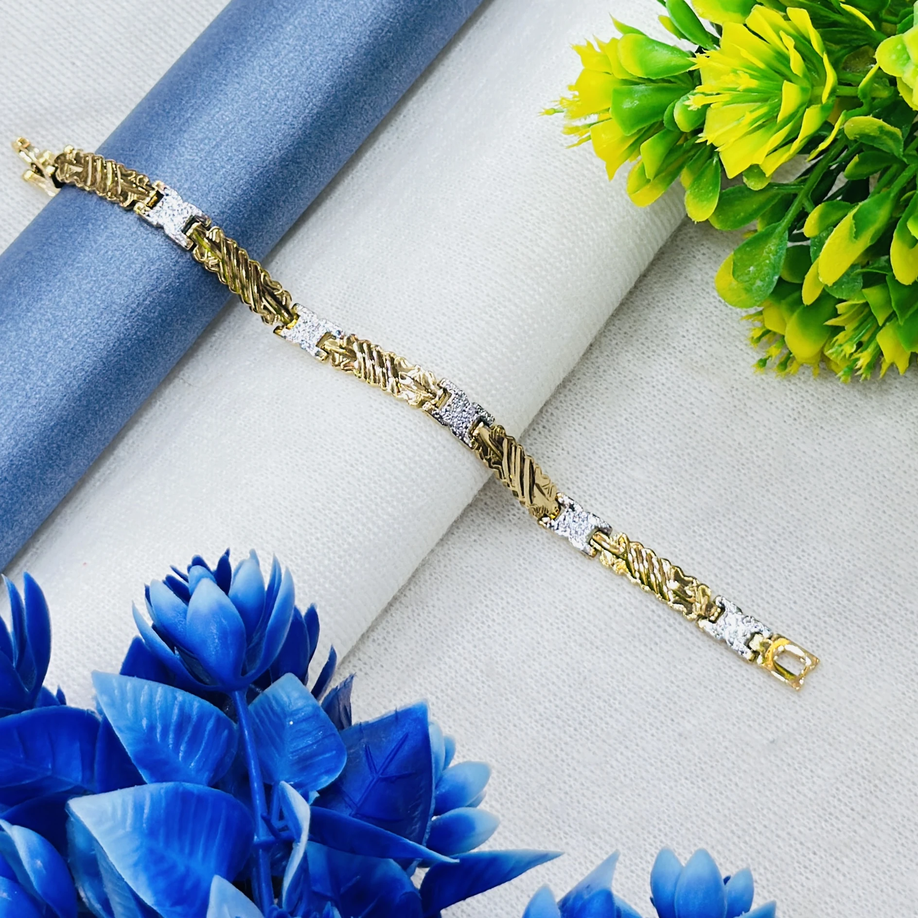 Gold plated men's bracelet featuring a textured, two-tone design.