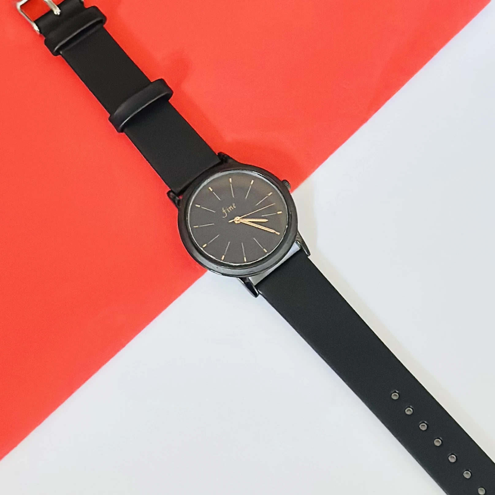 women's analog watch in black with a silicone strap.