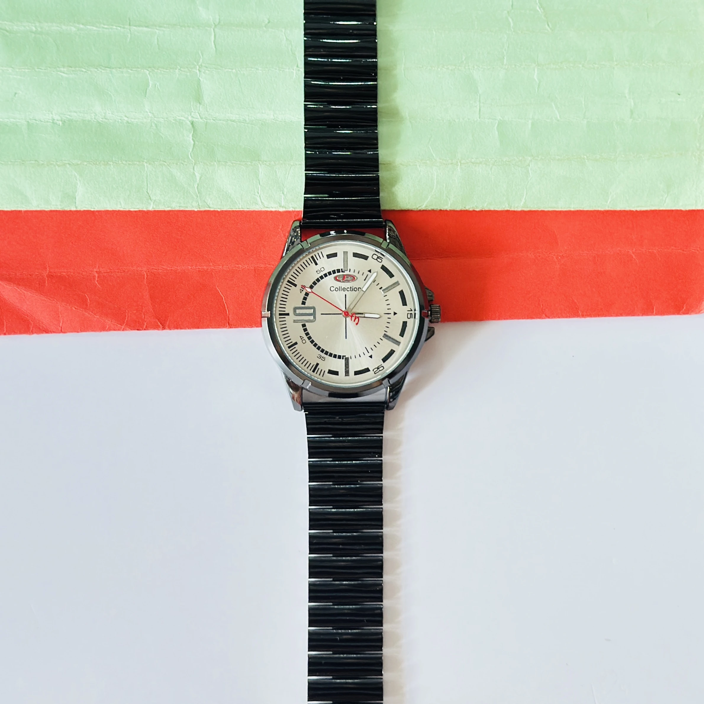 silver-toned dial and a black metal strap