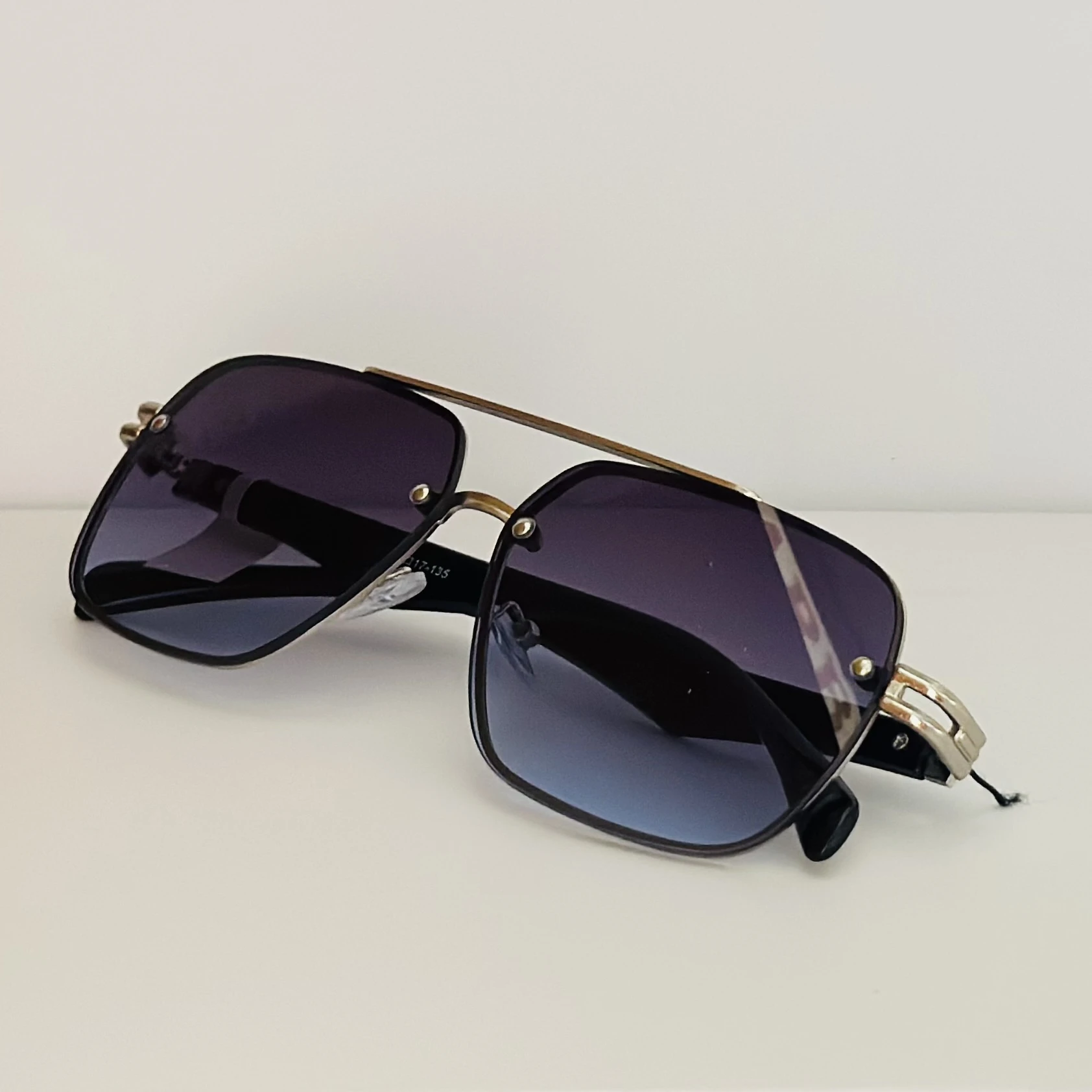GOGLASSIC GG2317 rectangle sunglasses featuring a silver-tone metal frame and blue gradient UV-protected lenses.