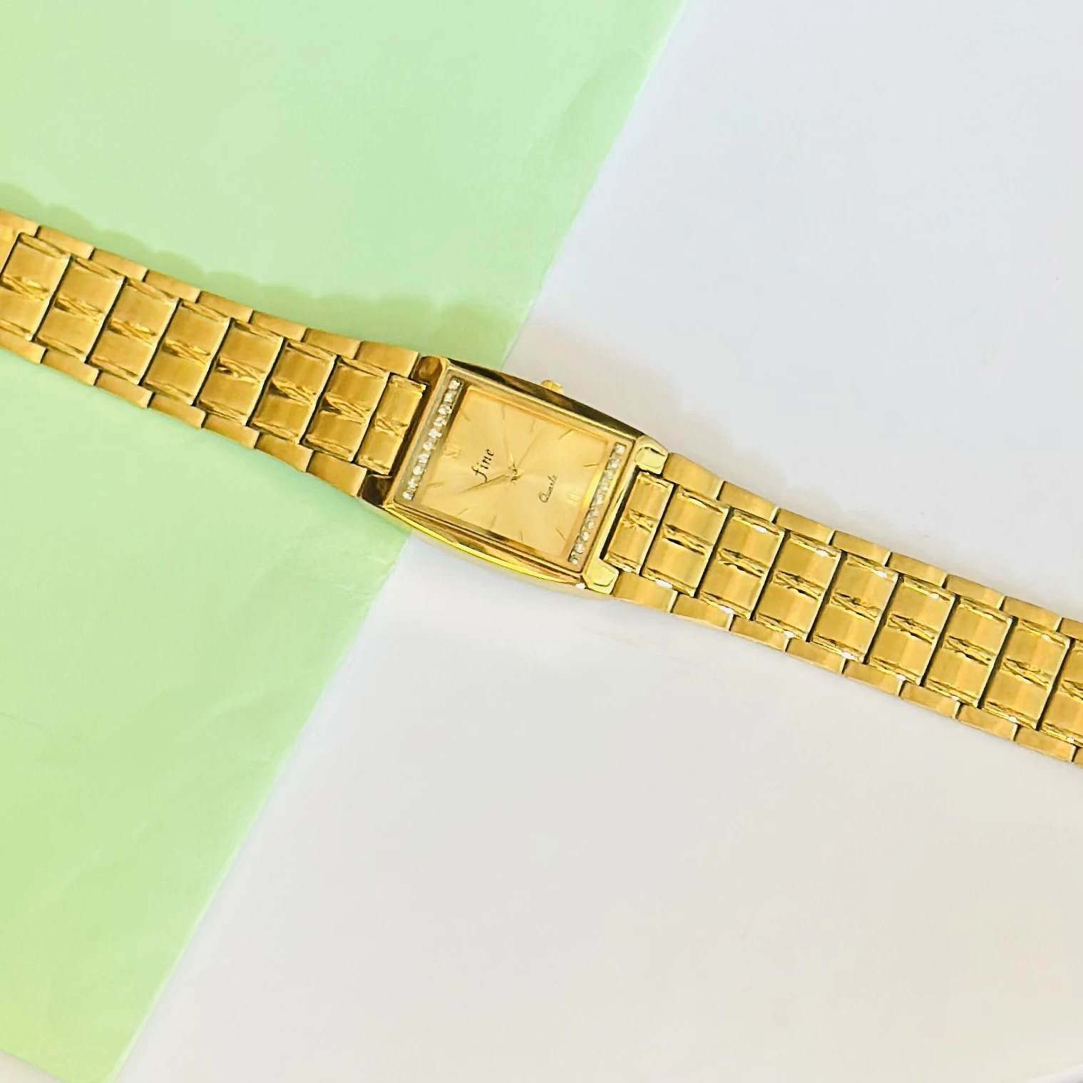 Gold plated stainless steel analog quartz watch.