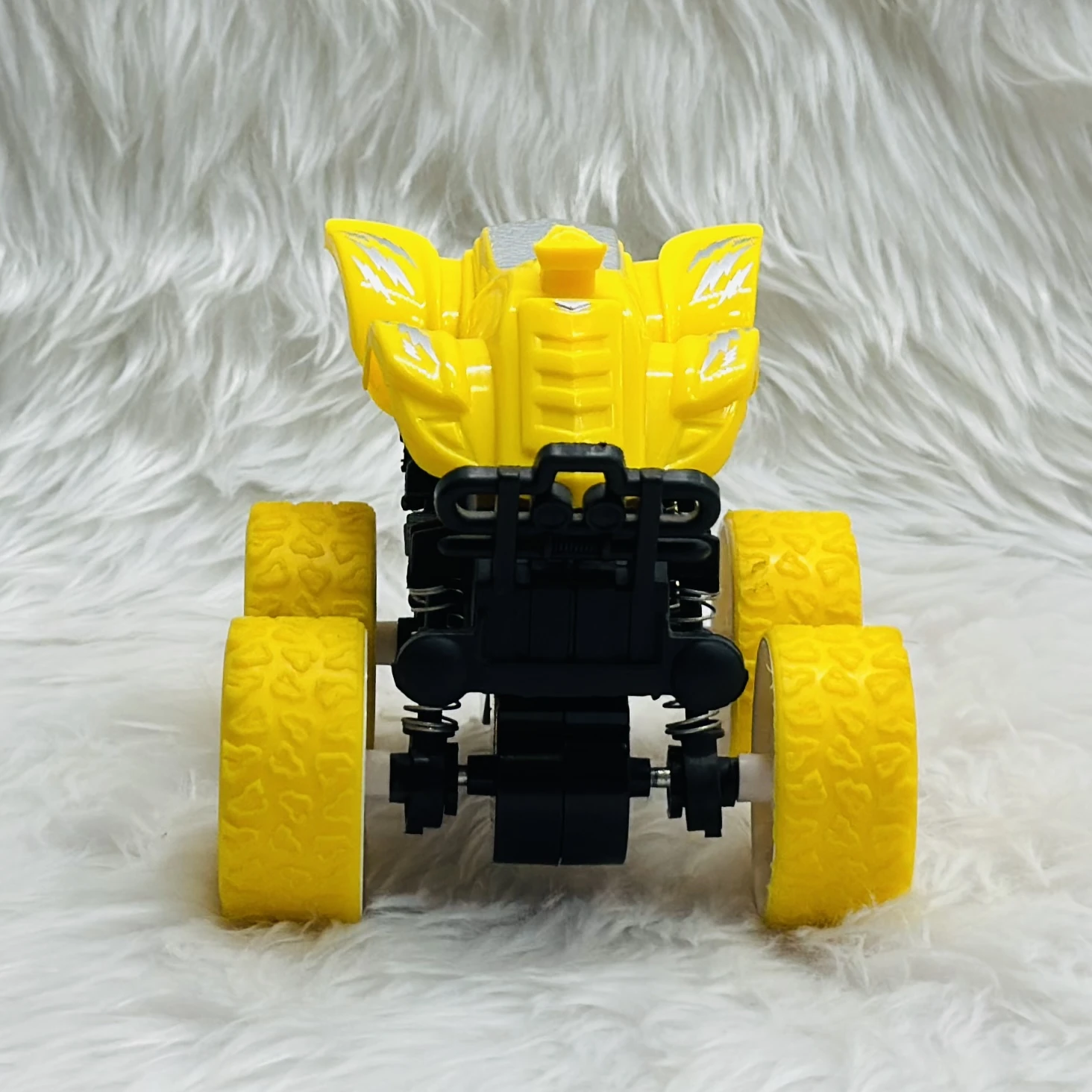 yellow friction-powered monster truck toy.
