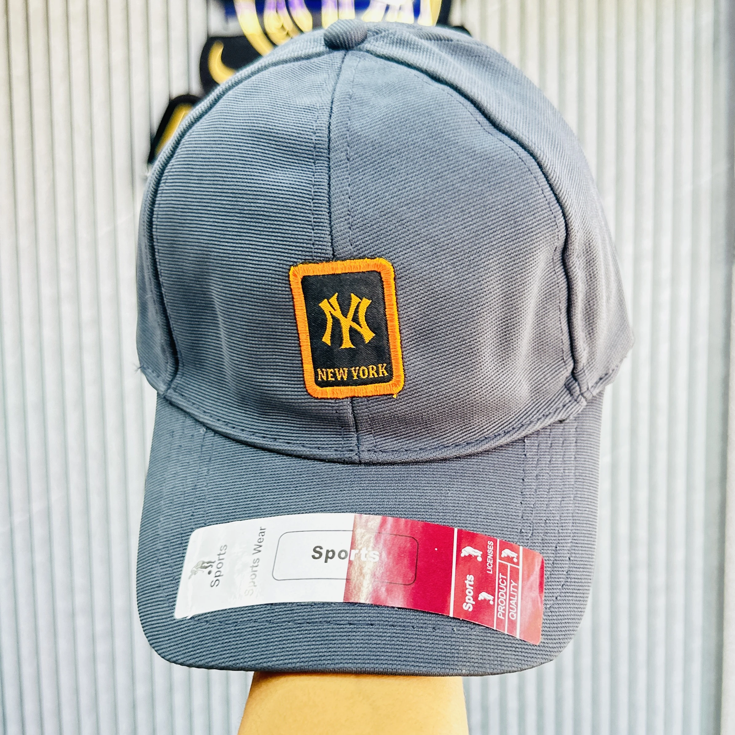 Gray baseball cap features the New York Yankees logo.