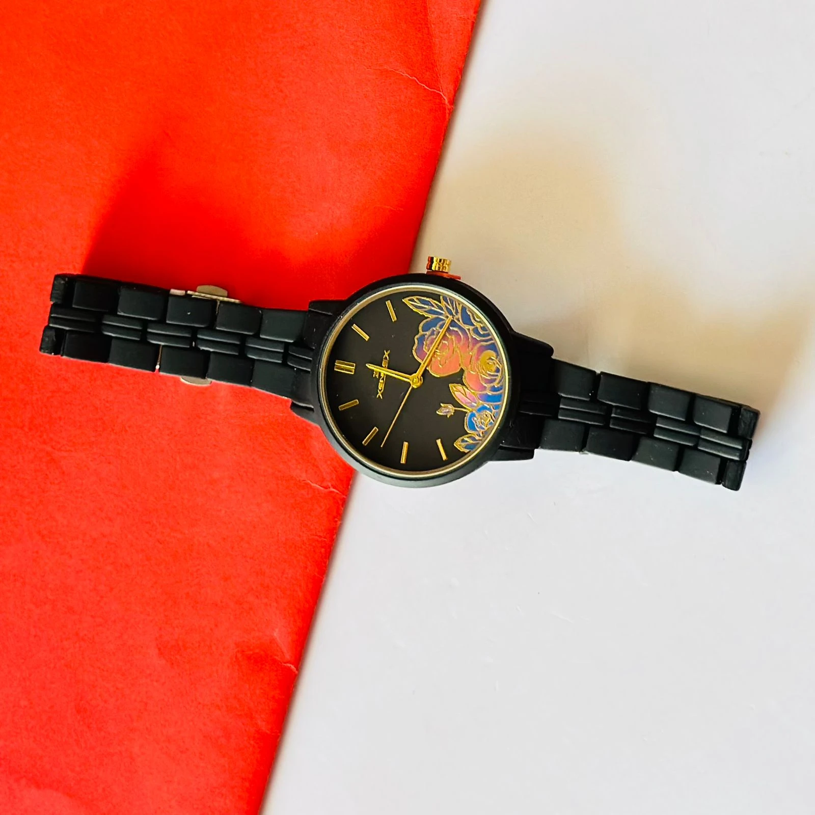 black metal analogue watch with a floral dial design