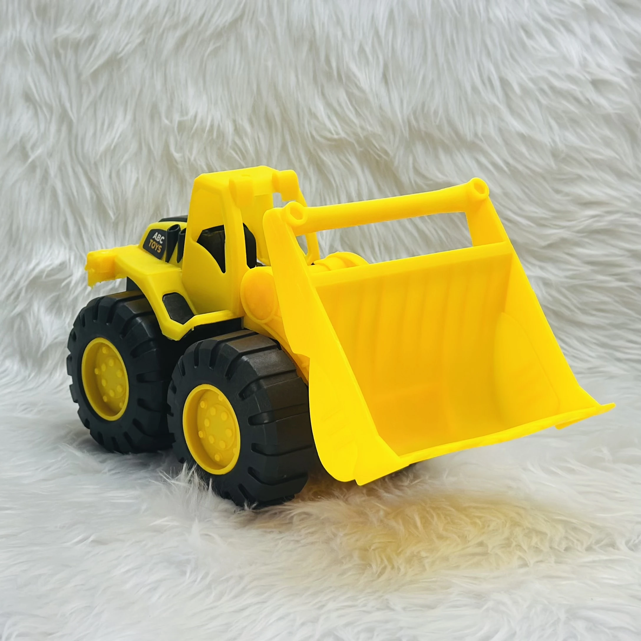 Yellow toy wheel loader,