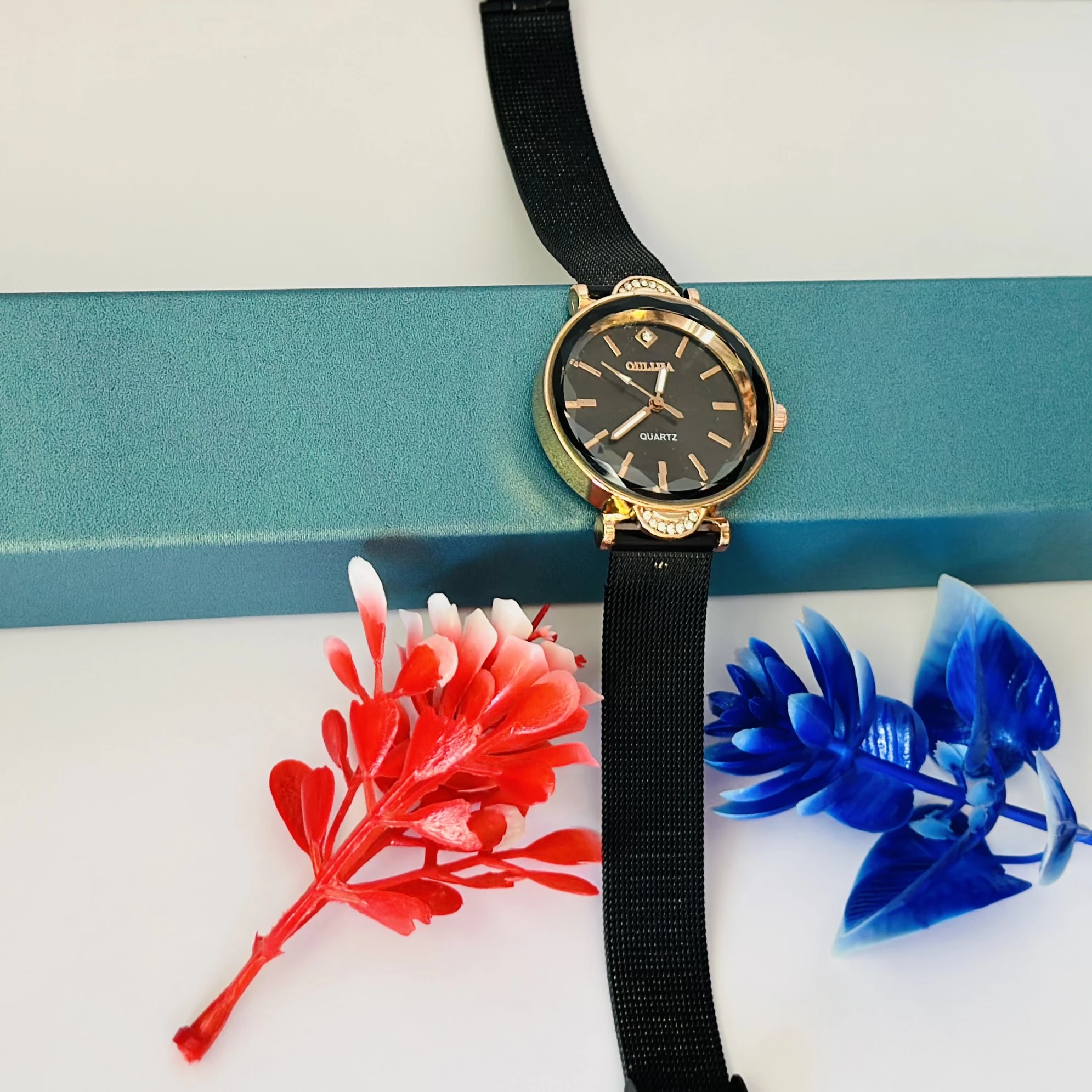 women's black mesh watch with a rose gold-tone case and a crystal accent.