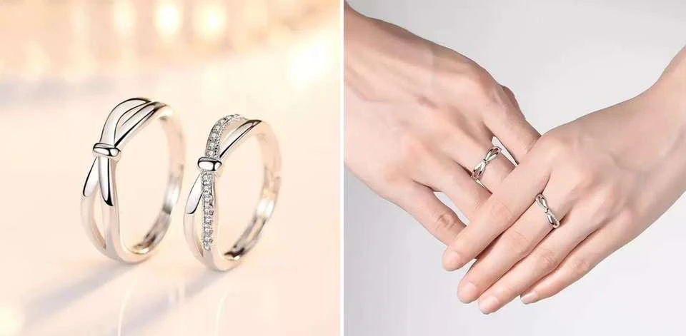 set of silver-plated, adjustable couple rings featuring a double bowknot design, with one ring studded with cubic zirconia stones.