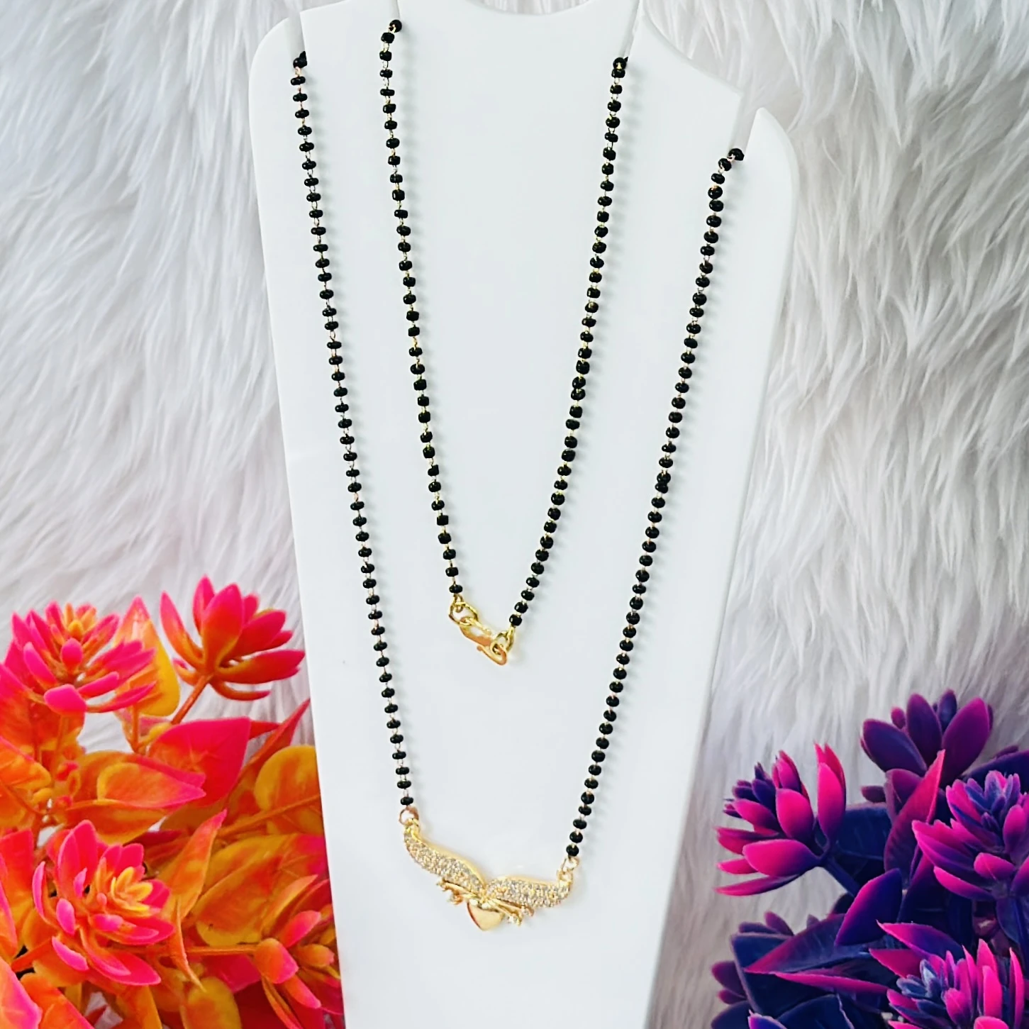 Gold plated mangalsutra with a cubic zirconia pendant.