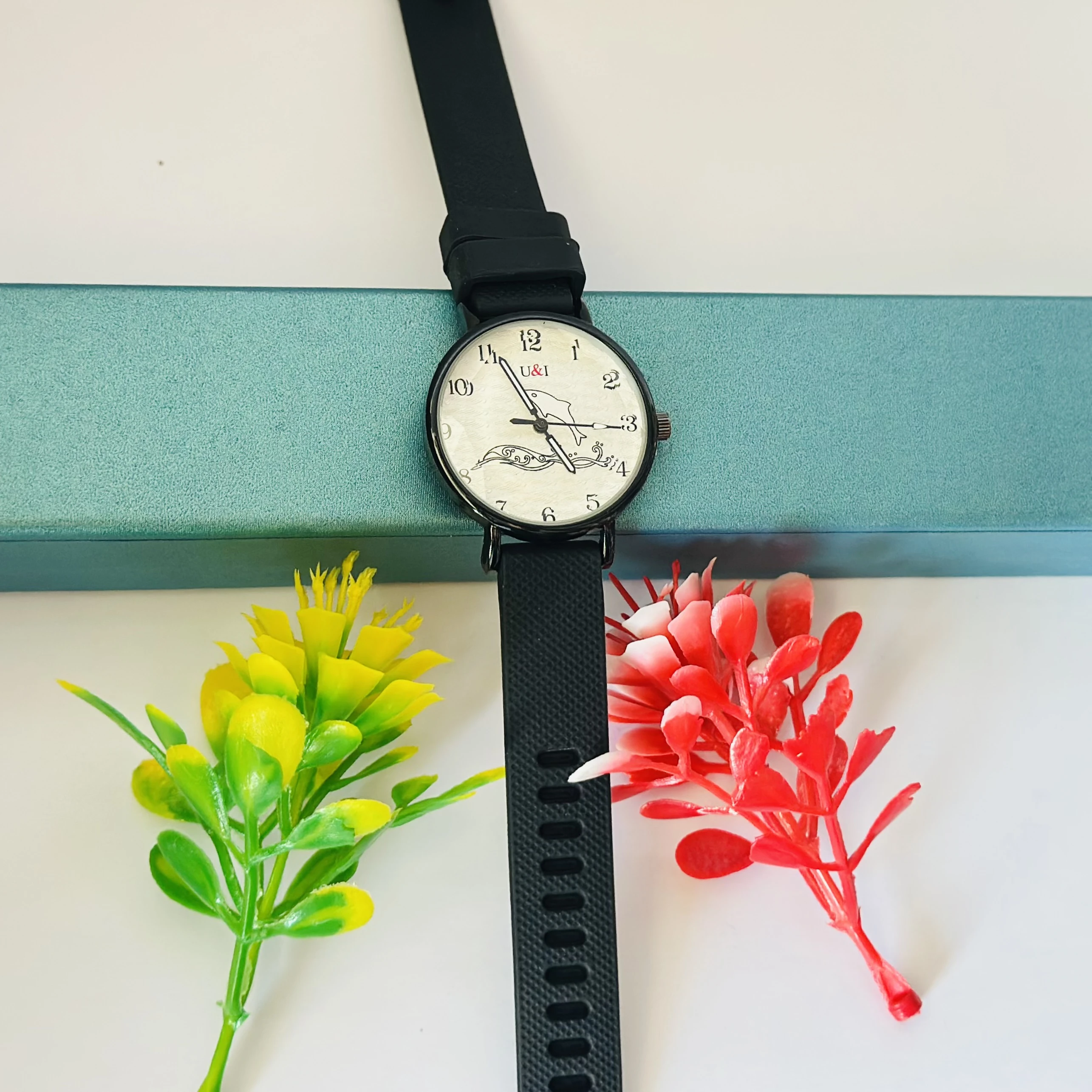 Analog wrist watch with a black rubber strap