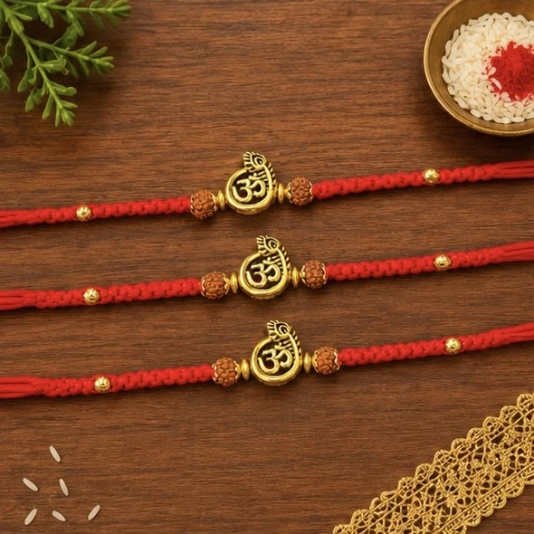 Red and golden Om symbol designer Rakhis, typically sold in sets for Raksha Bandhan.