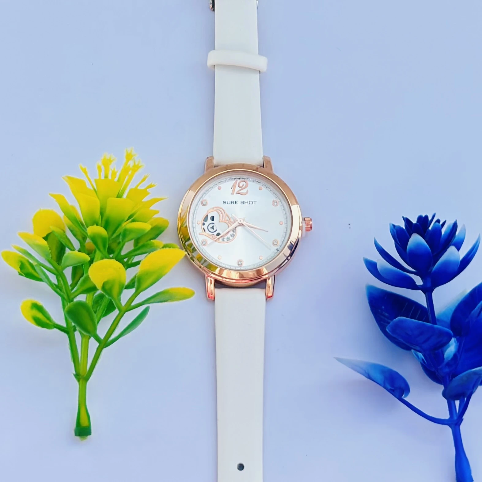Sure Shot women's analog watch with a rose gold case, white dial, and white silicone strap