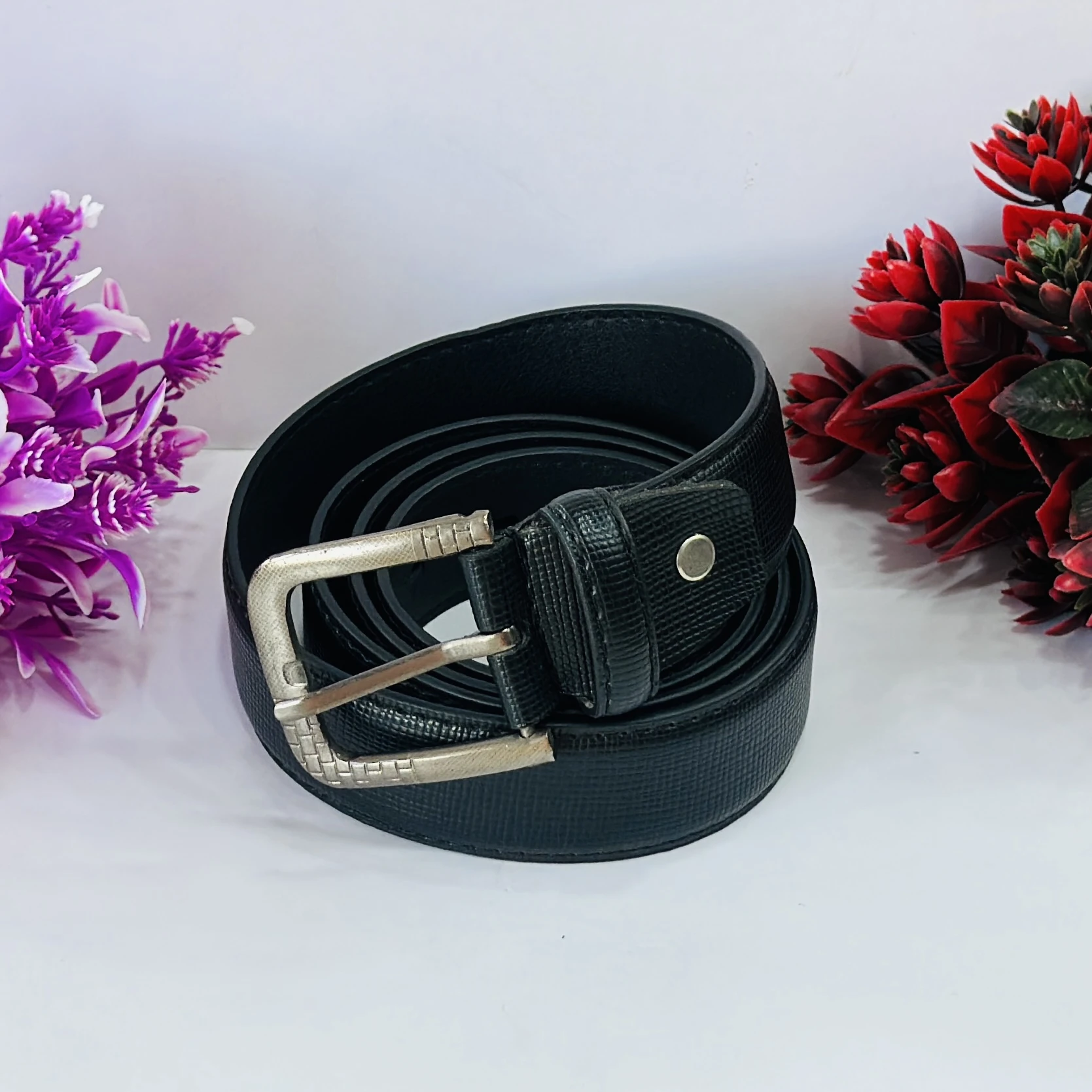 Black leather belt with a metal buckle.