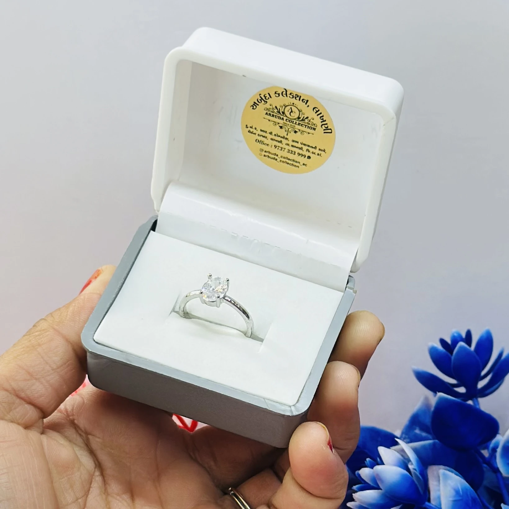 silver solitaire ring with a moissanite stone.