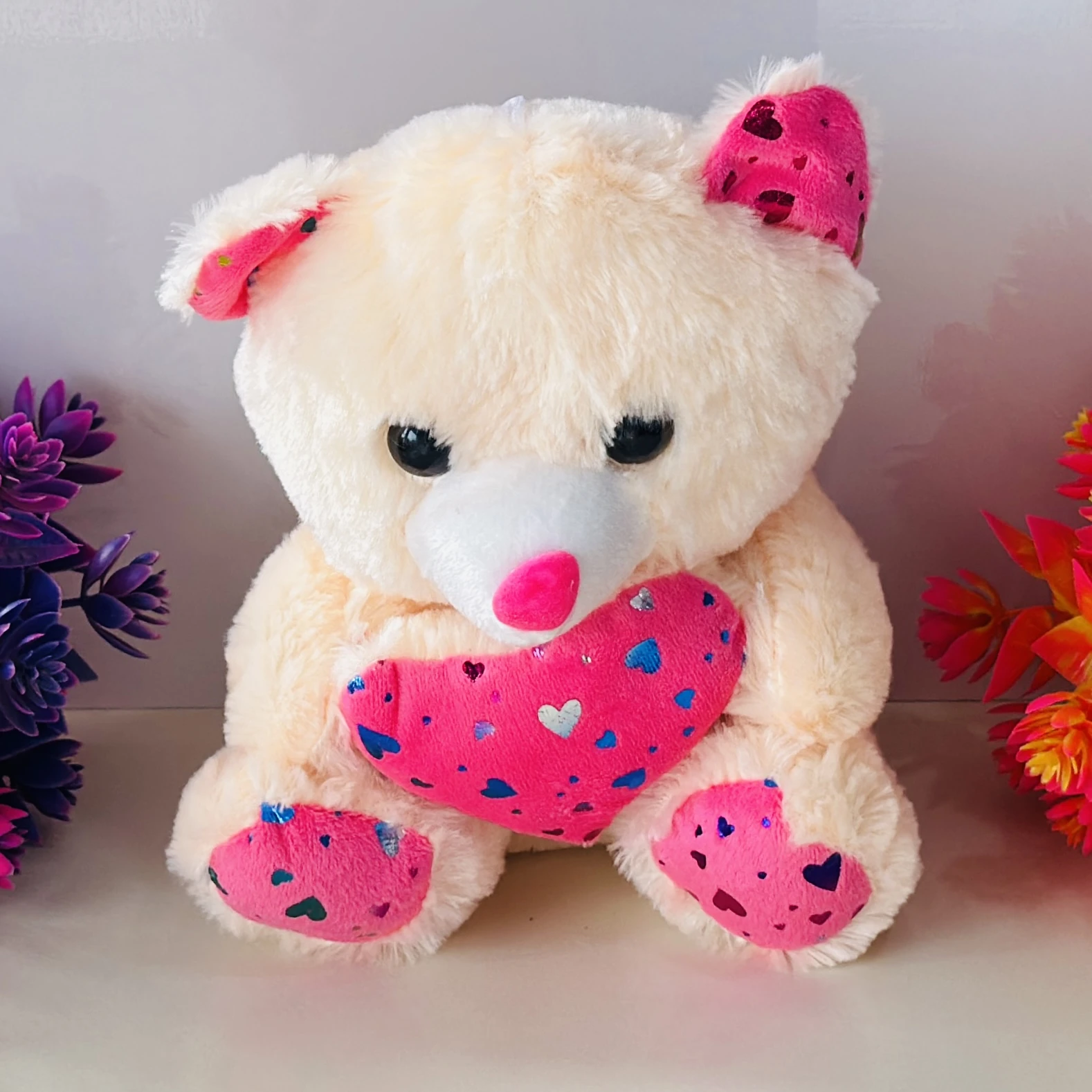 white teddy bear stuffed toy with a pink heart.