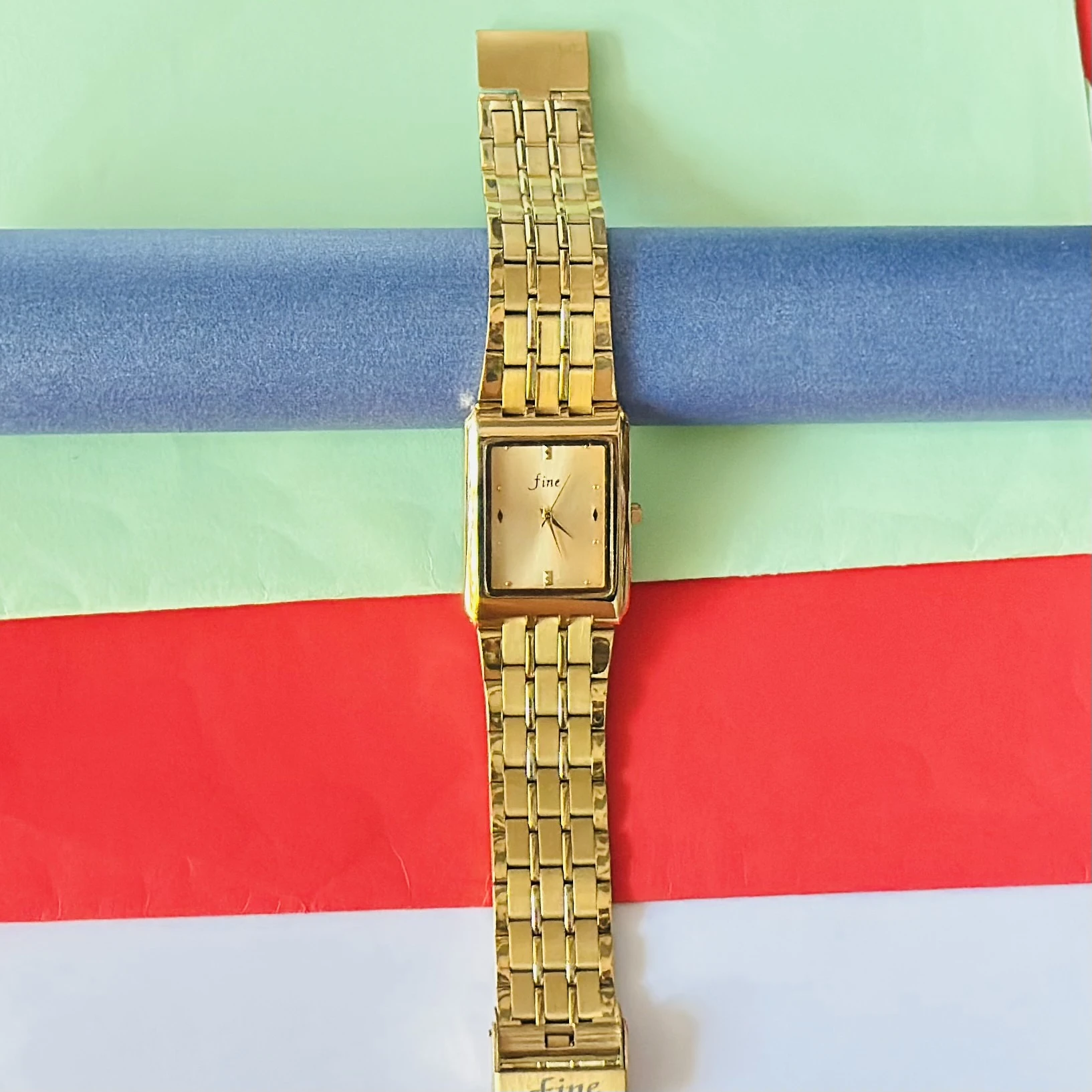 Gold -tone analog quartz watch with a metal strap.