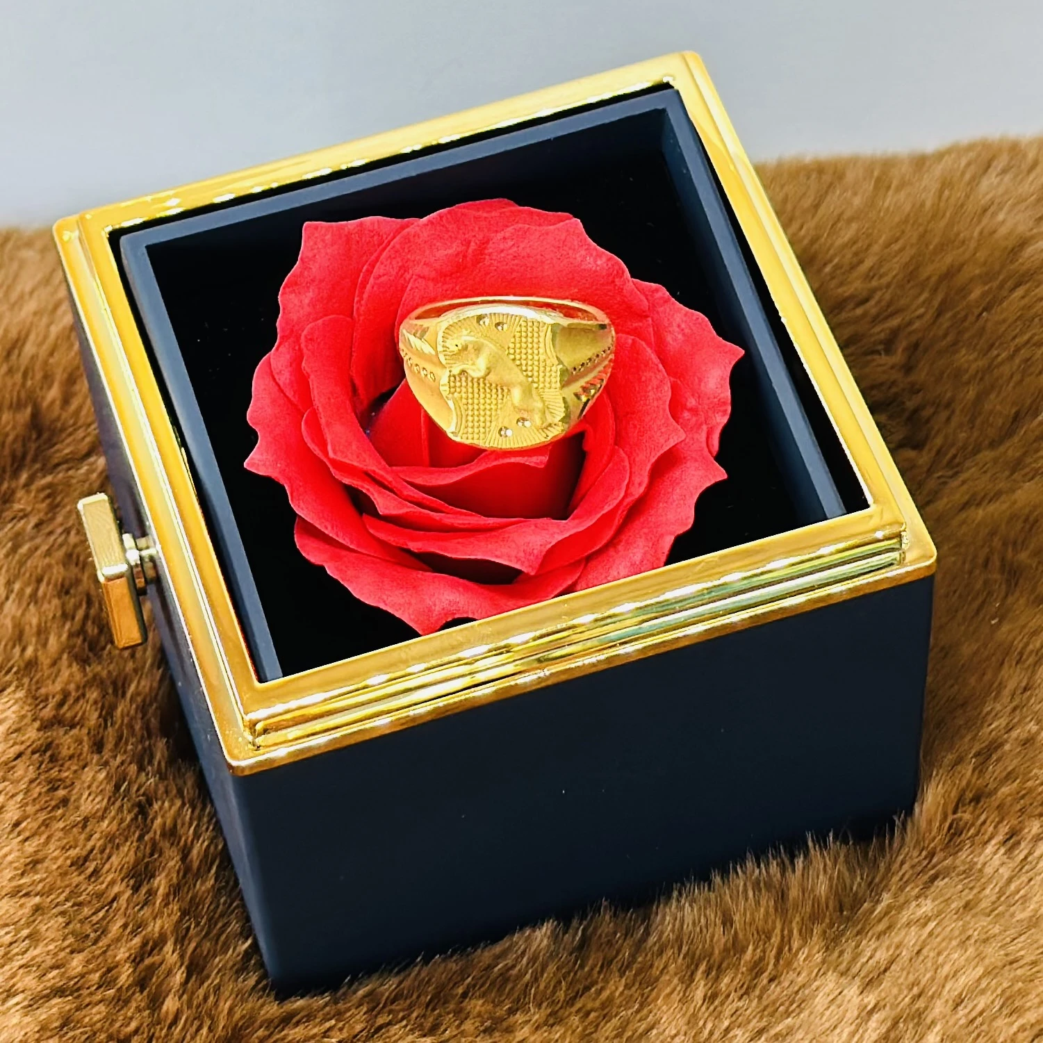 Gold toned men's ring with an embossed design