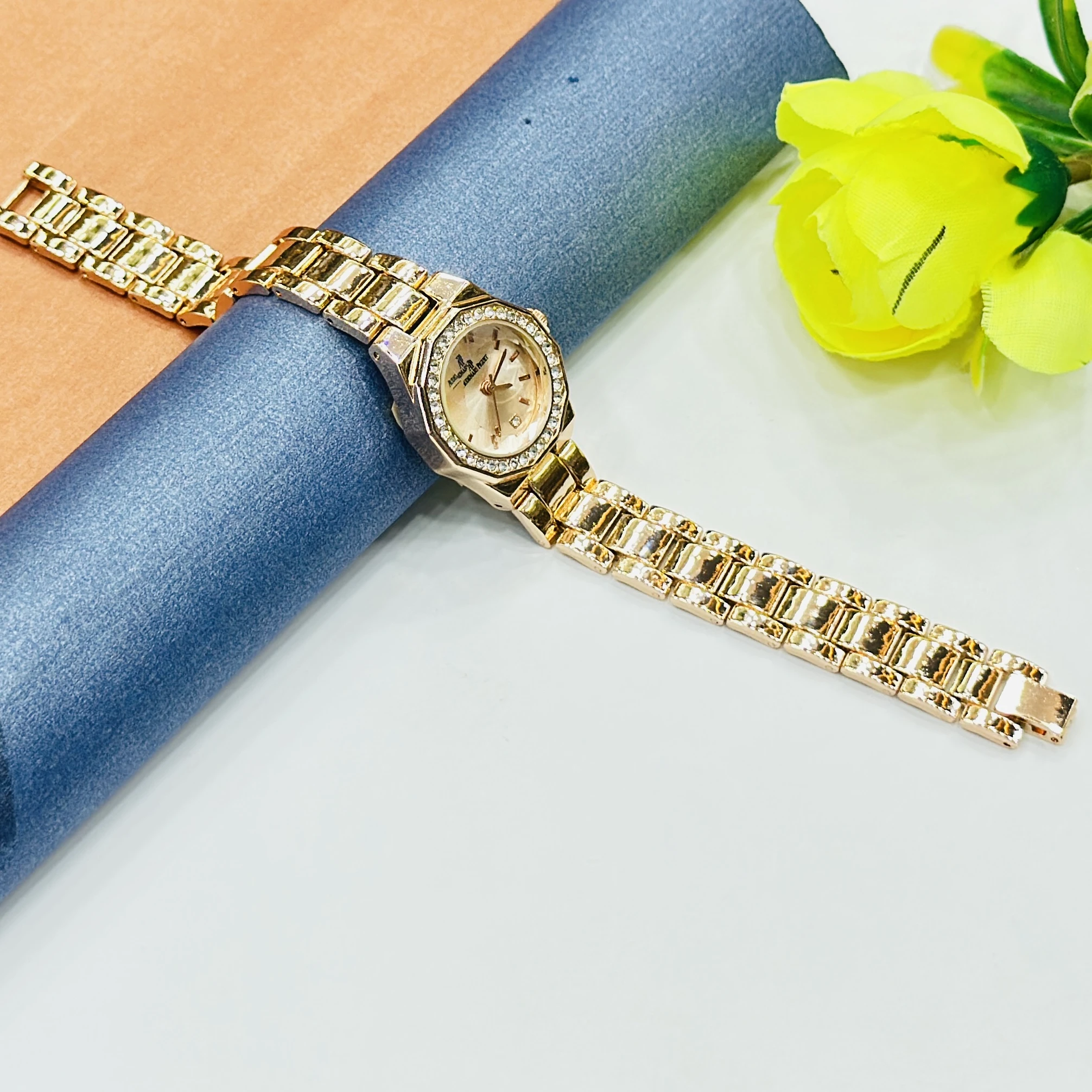 gold-tone ladies' watches with a sparkling bezel and metallic strap