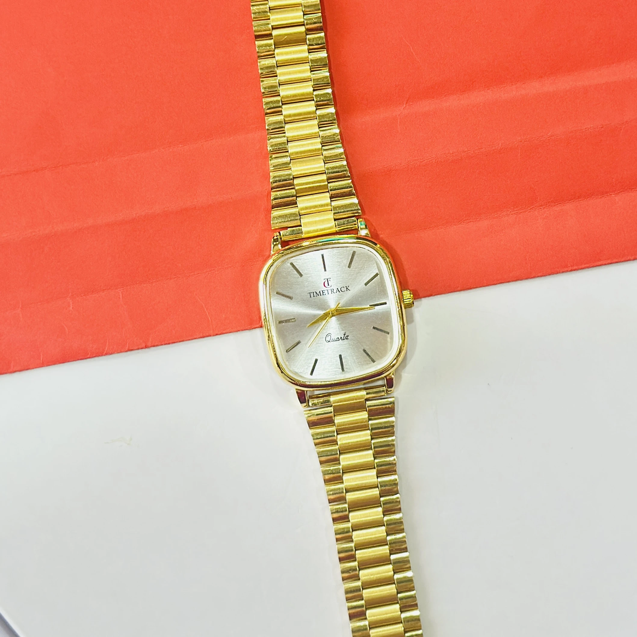 Gold coloured analogue watch