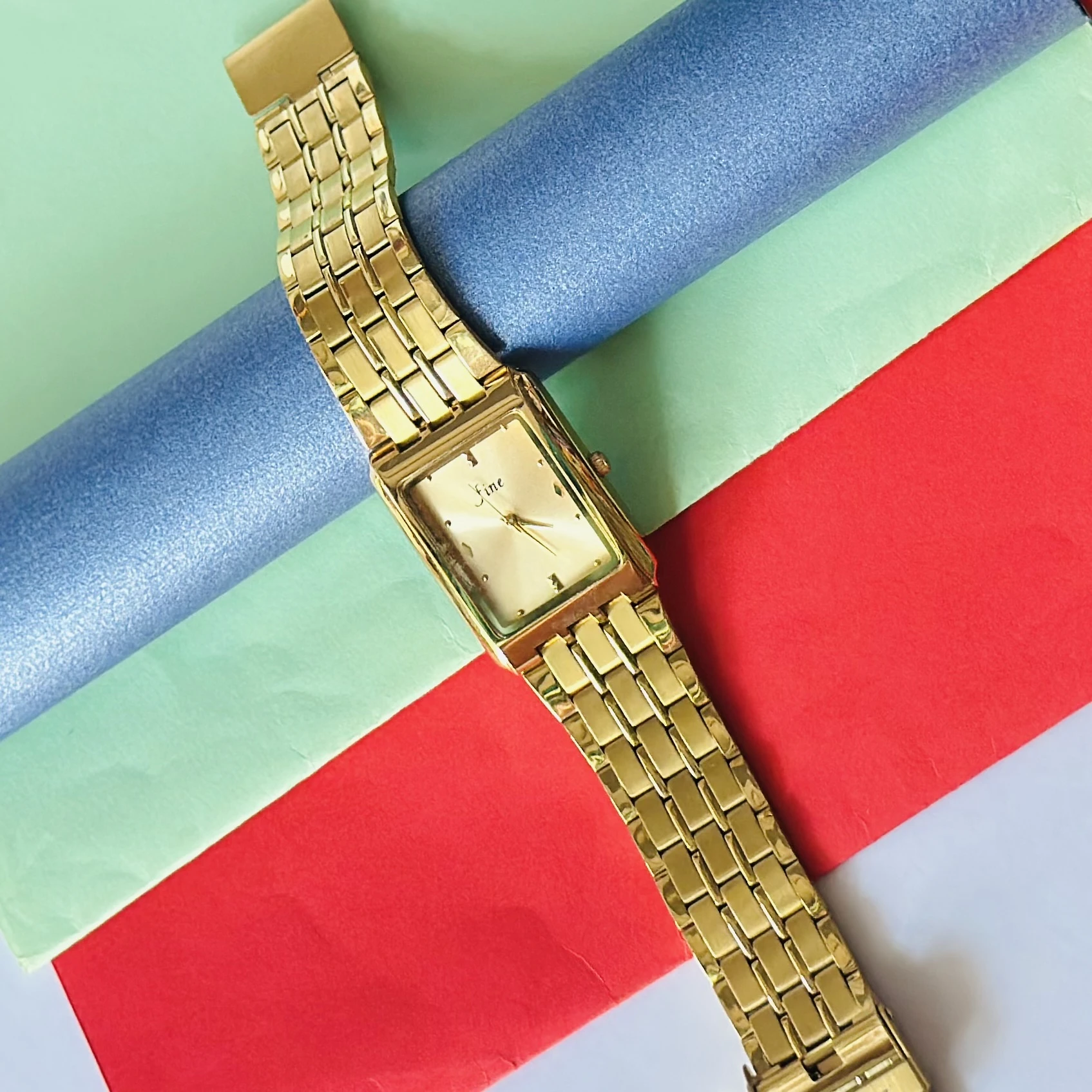 Gold -tone analog quartz watch with a metal strap.