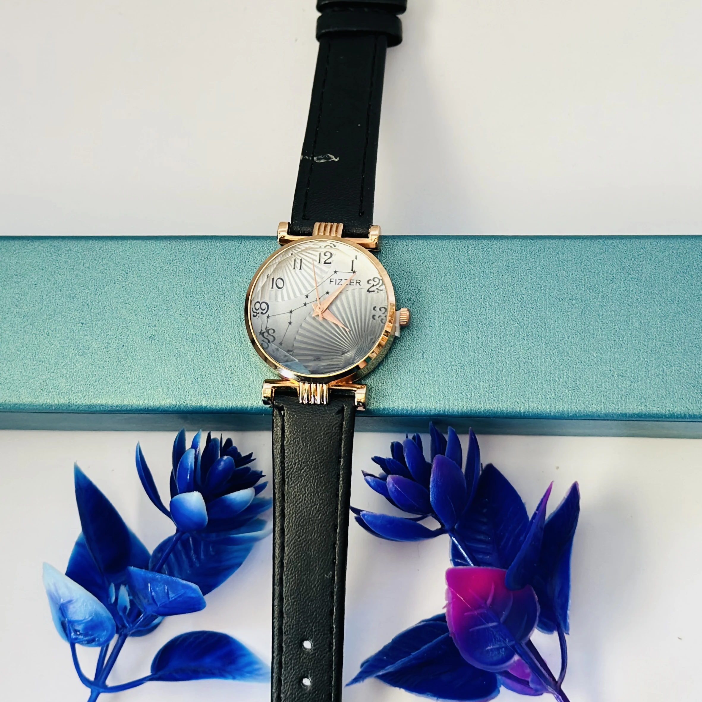 women's analog watch with a black leather strap and a rose gold-toned case.