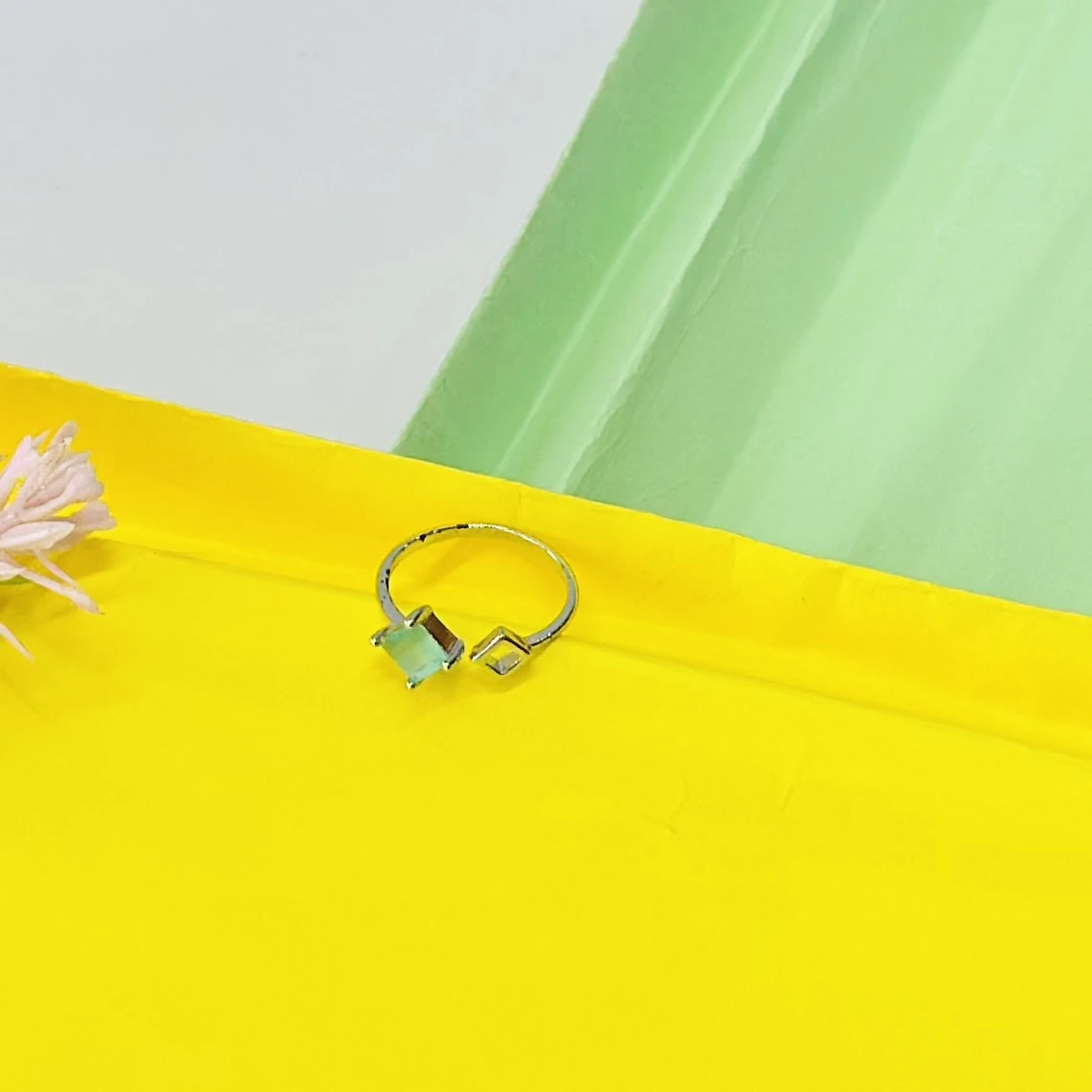 an adjustable silver-toned ring with a black heart and a clear stone accent.