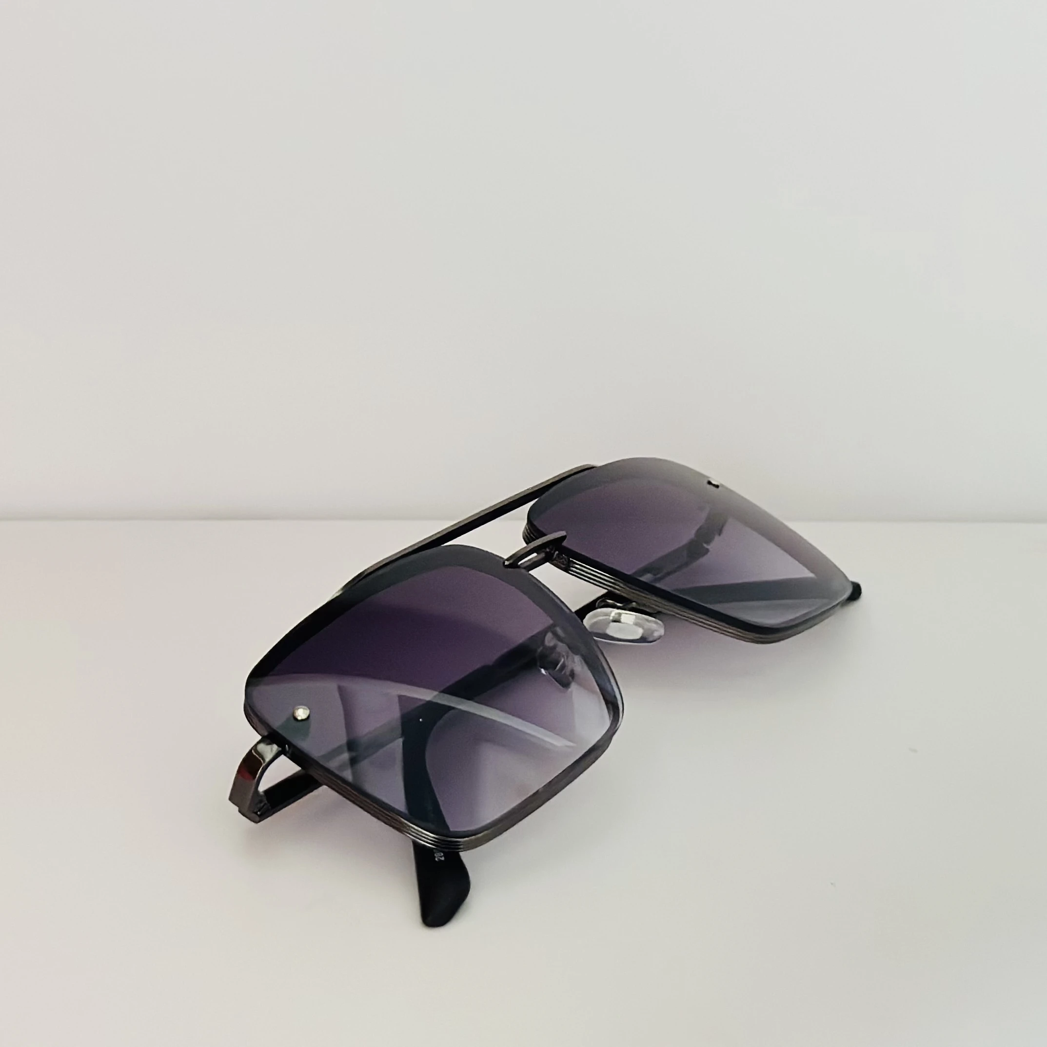 Black metal-framed square sunglasses with gradient lenses.