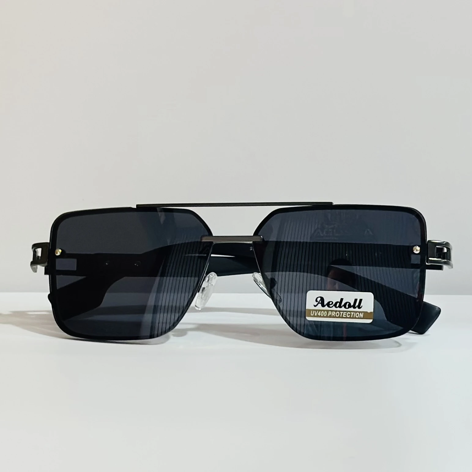pair of square aviator sunglasses with a black metal frame and gradient lenses.