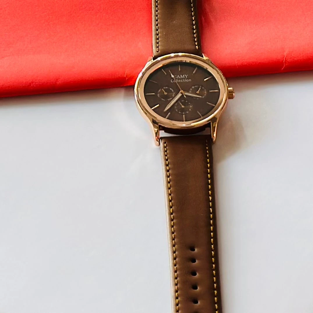 Round analog watch with a brown leather strap