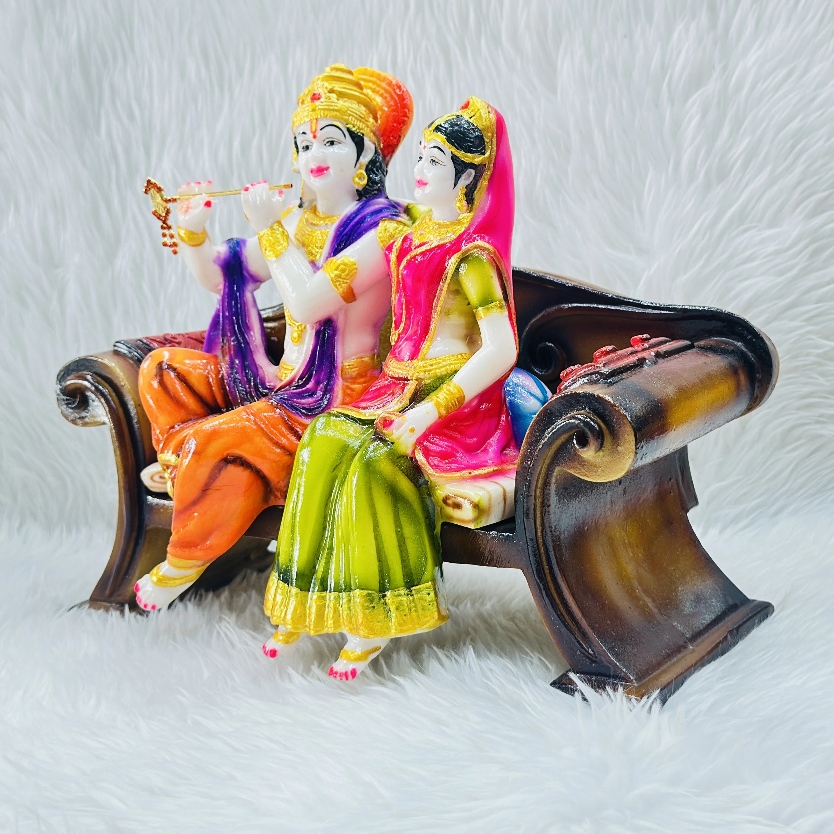 polyresin and fiberglass handicraft idol of Radha Krishna sitting on a decorative bench