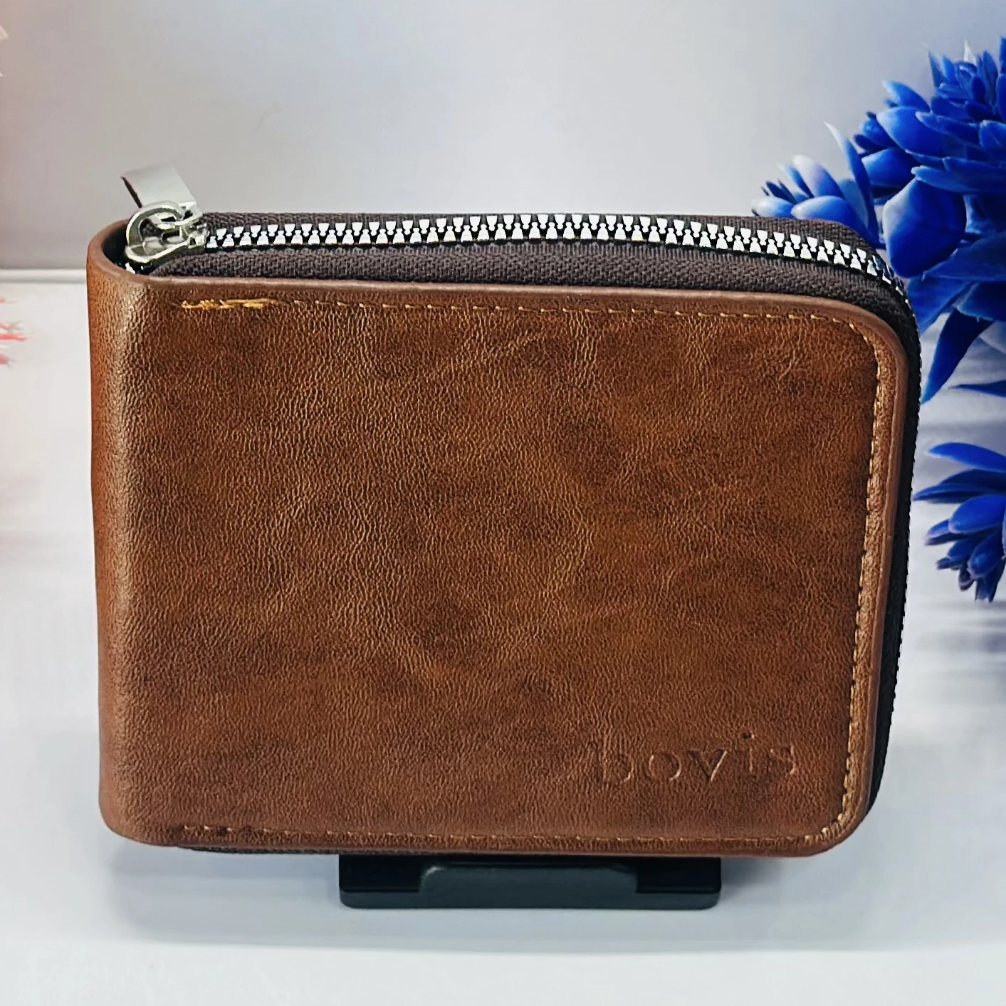 brown leather zip-around wallet with a "bovis" logo.