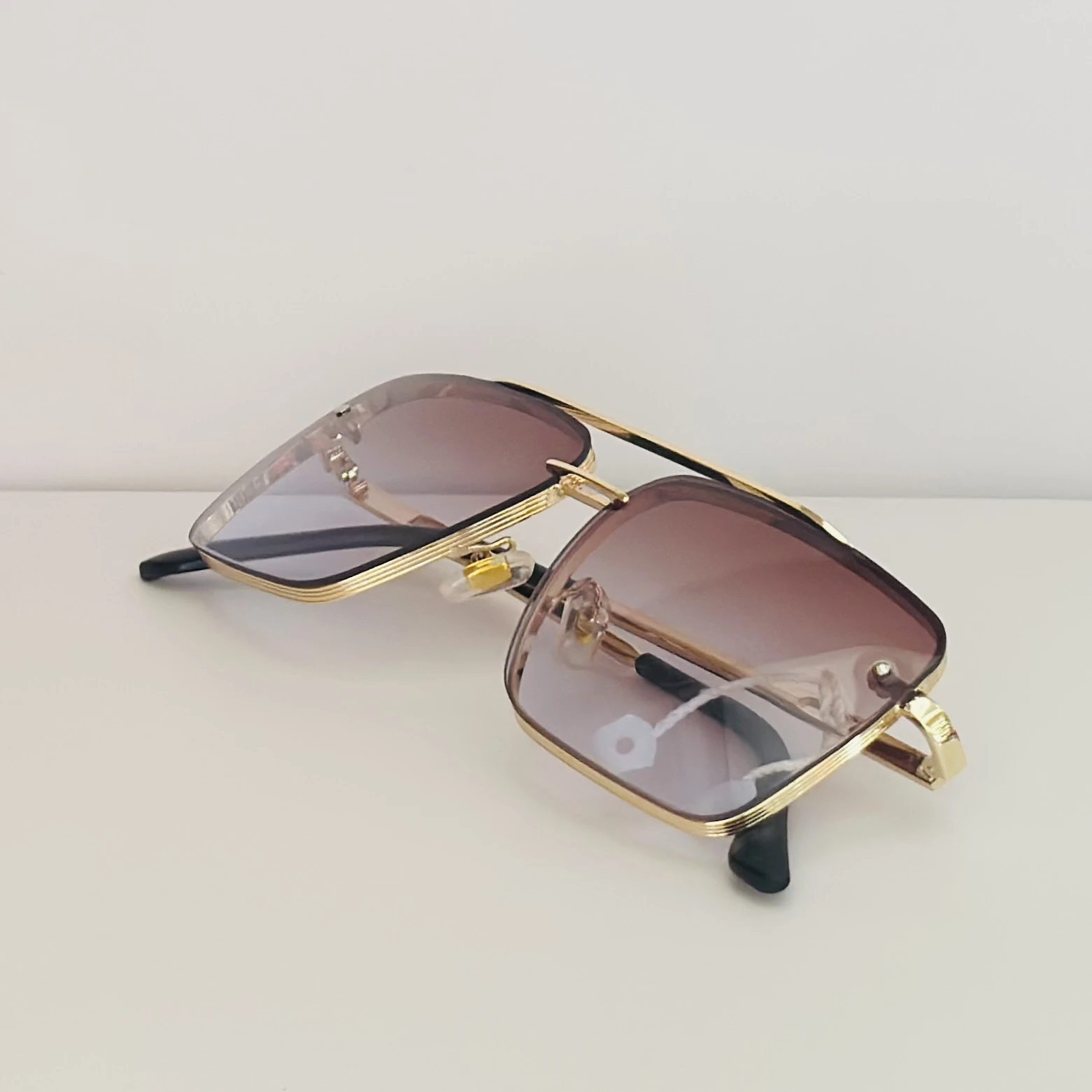 pair of DITA Mach-Six sunglasses with gold-tone frames and brown-to-clear gradient lenses