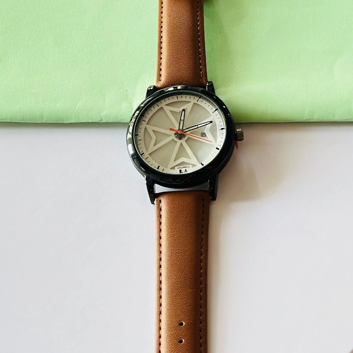 Round analog watch with a brown leather strap