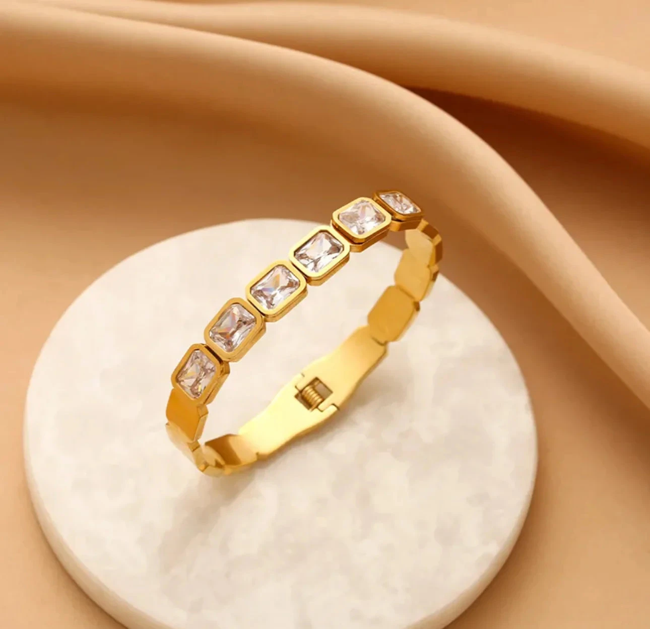 Gold tone hinged bangle bracelet