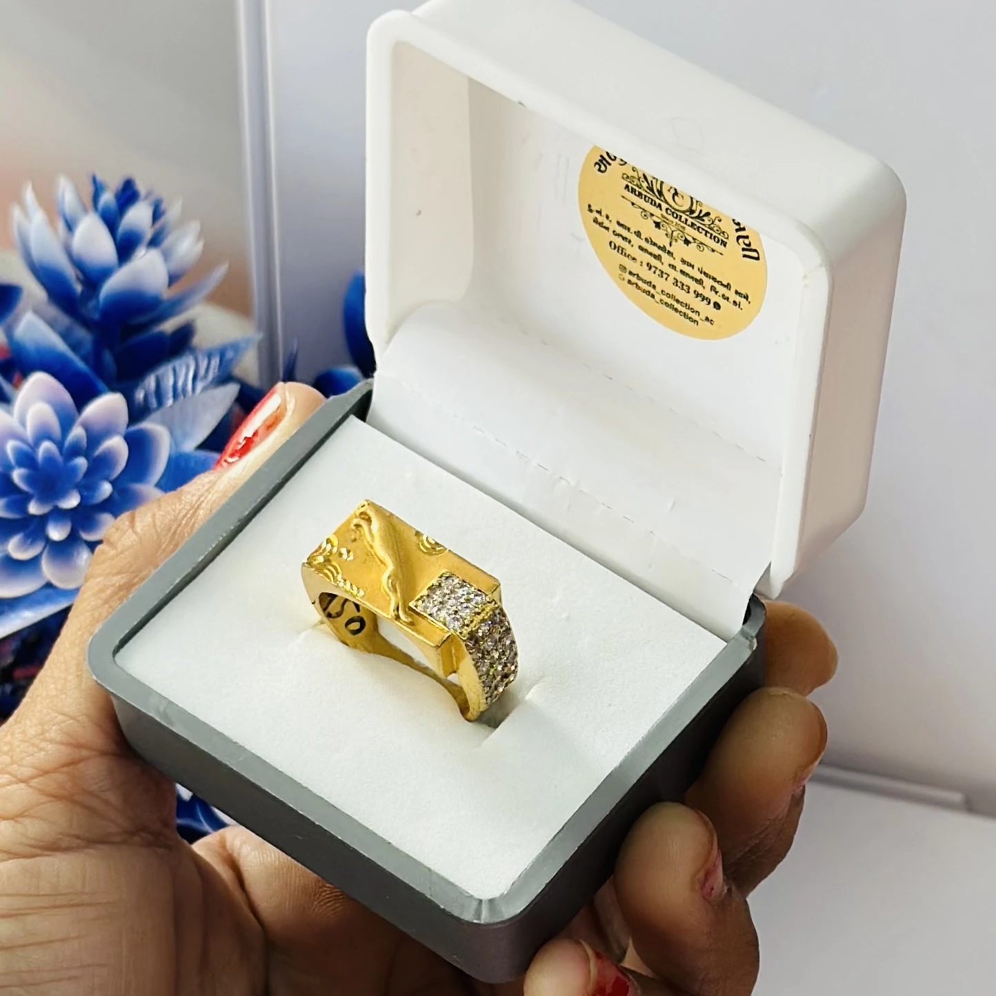 gold gent's ring with a textured design and diamond accents.