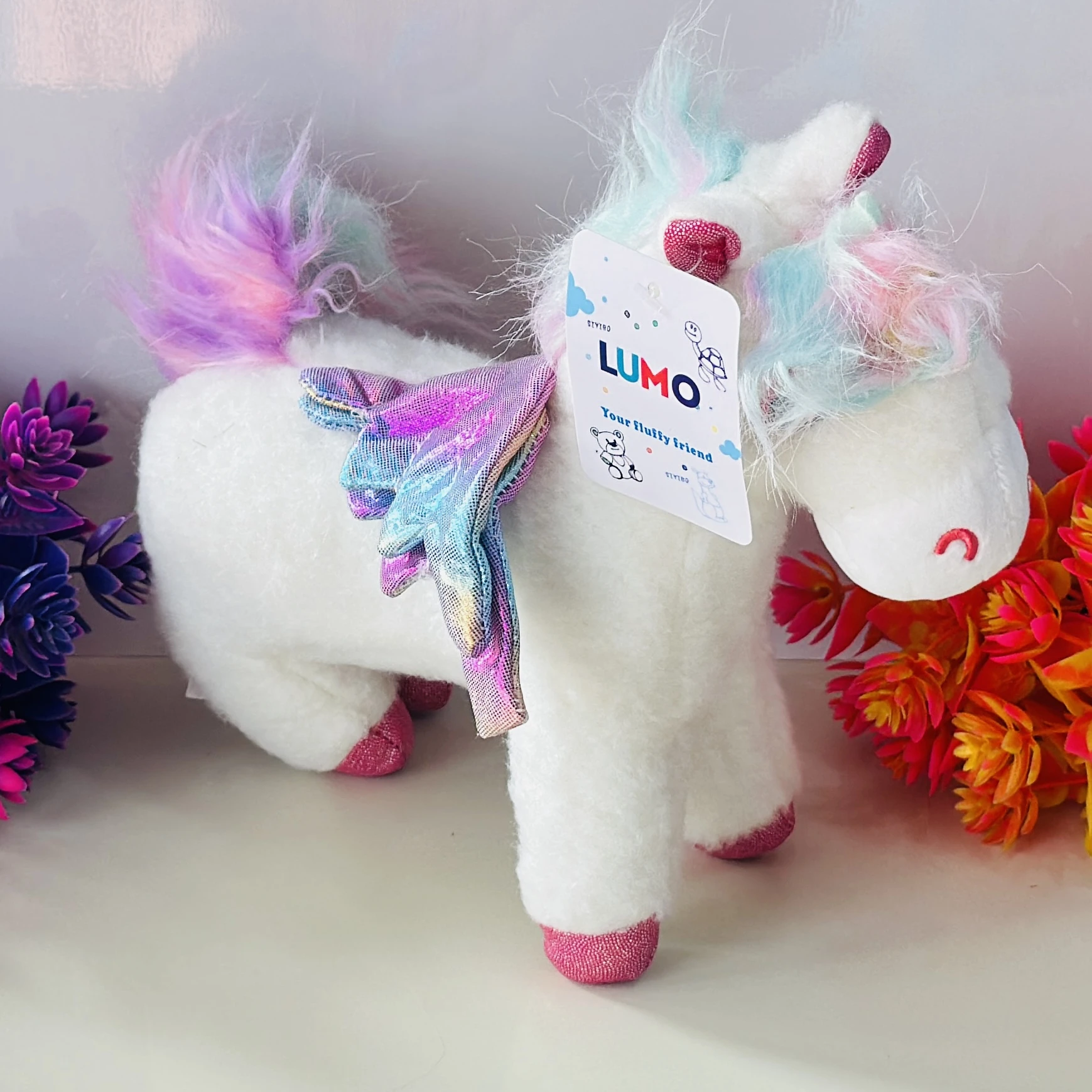 white unicorn plush toy.