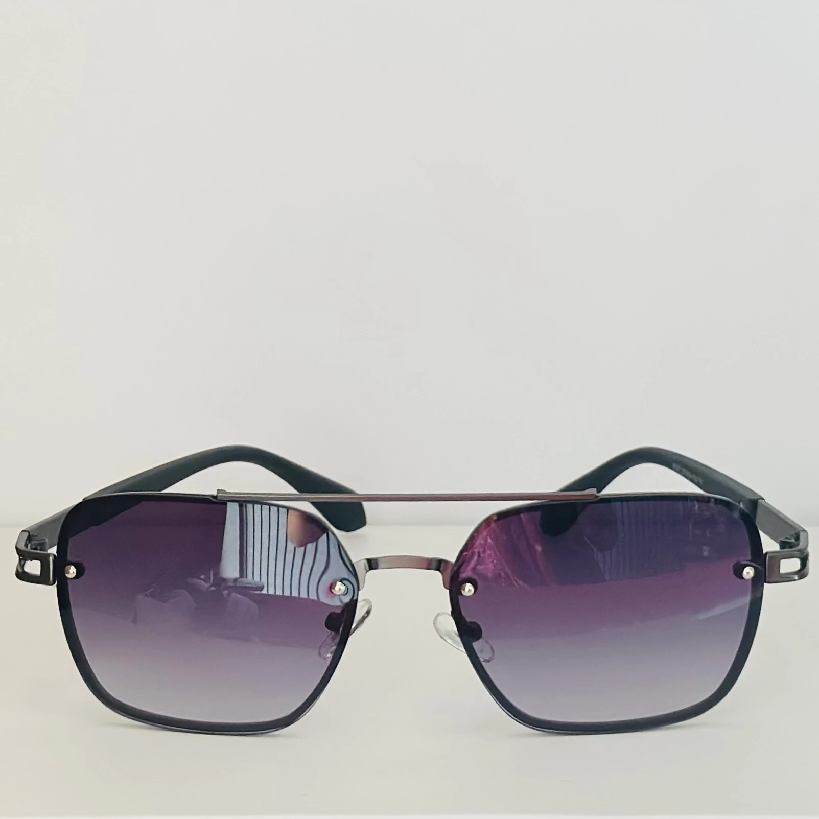 pair of Maybach square-style sunglasses with a black metal frame and dark gradient lenses