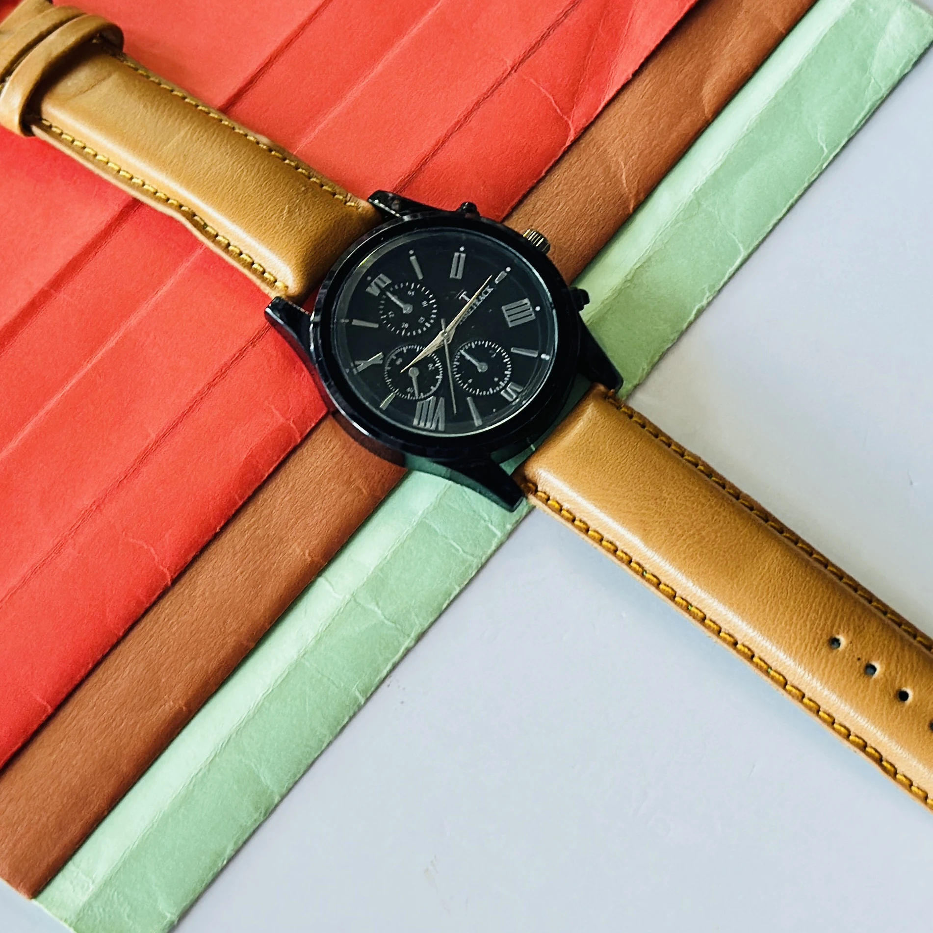 Timetrack quartz analog watch with a black dial and a brown leather strap.
