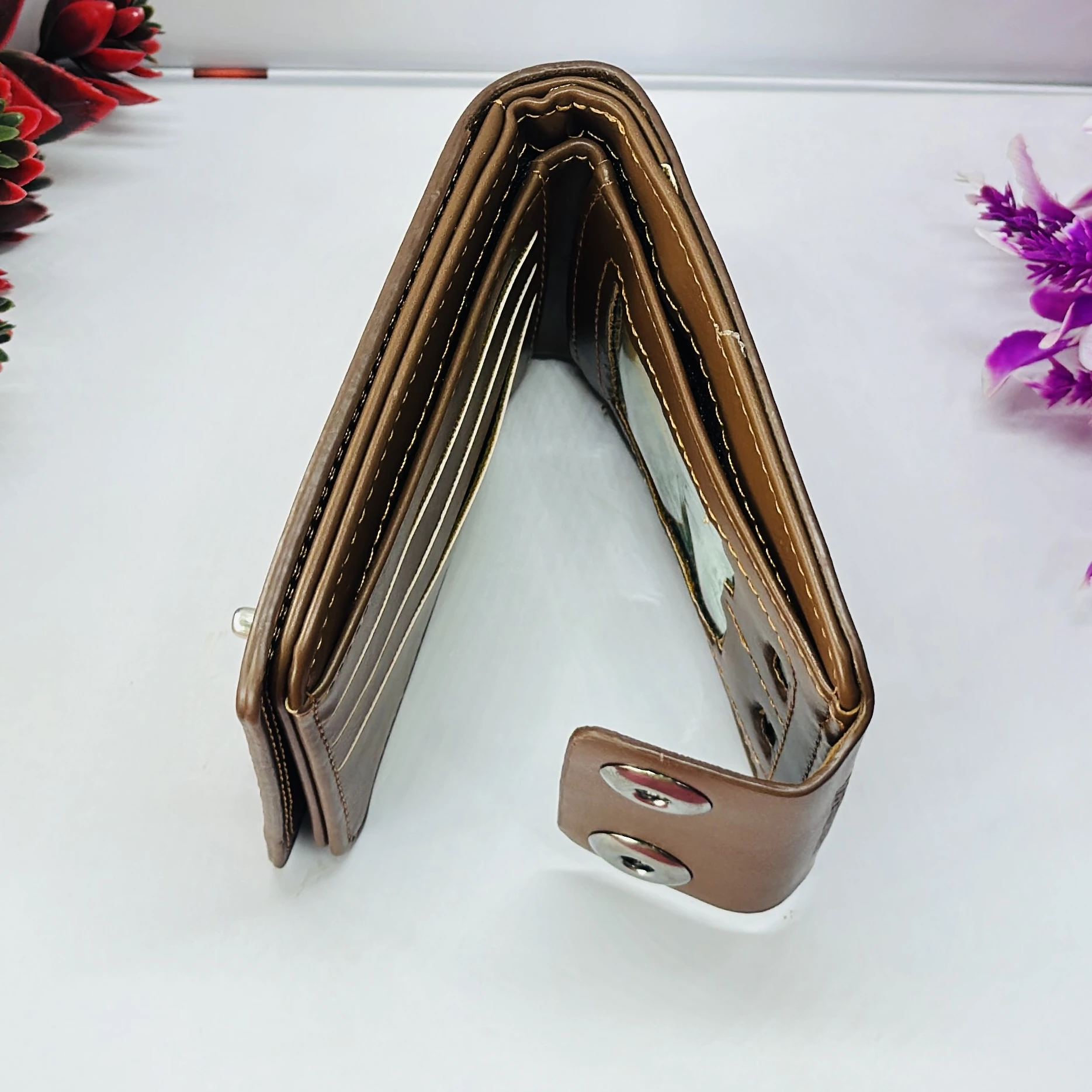 brown men's BALISI wallet with a textured pattern and snap closure.